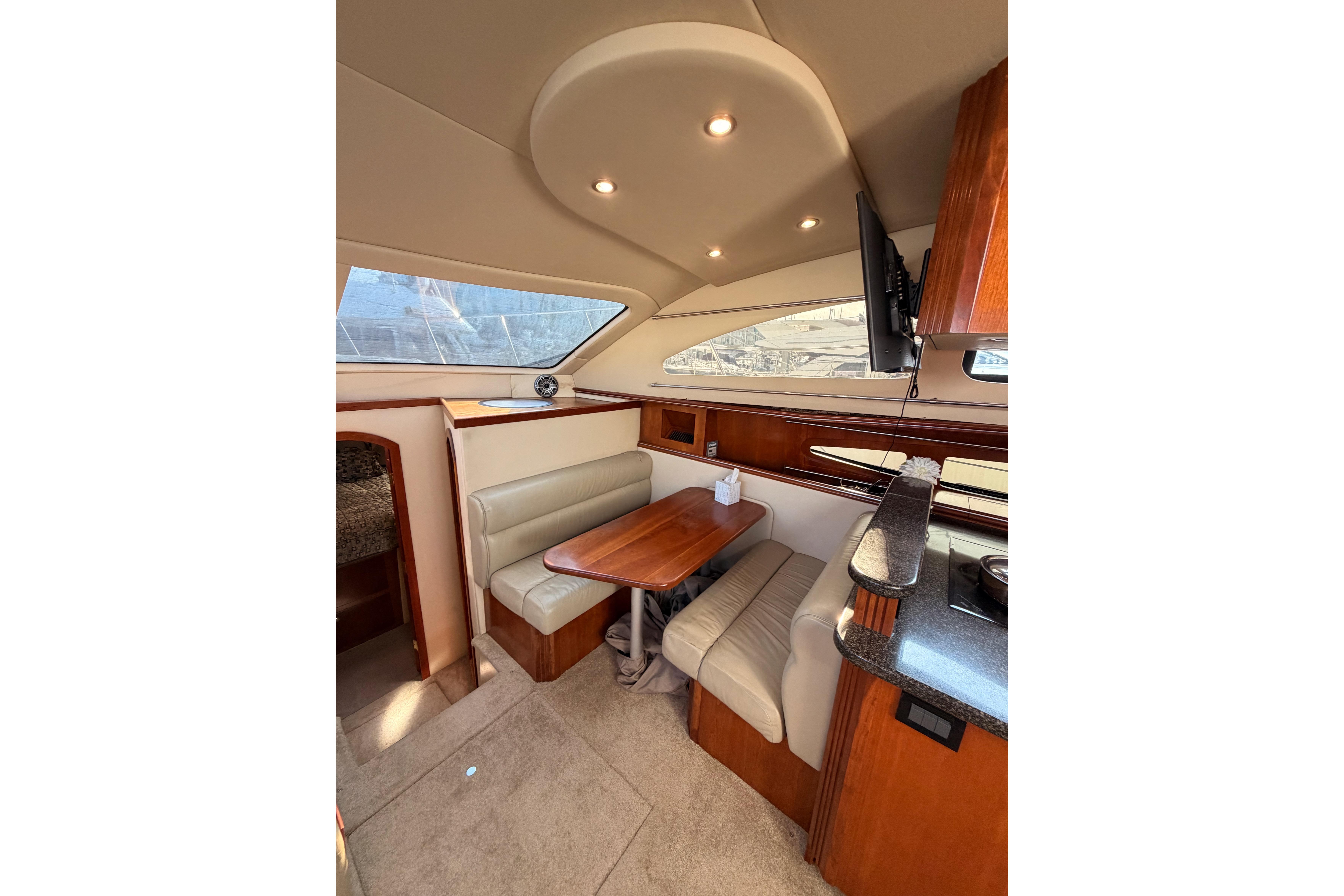 Luxurious interior of 2005 Cruisers Yachts 405 Express Motoryacht with elegant seating and dining area.