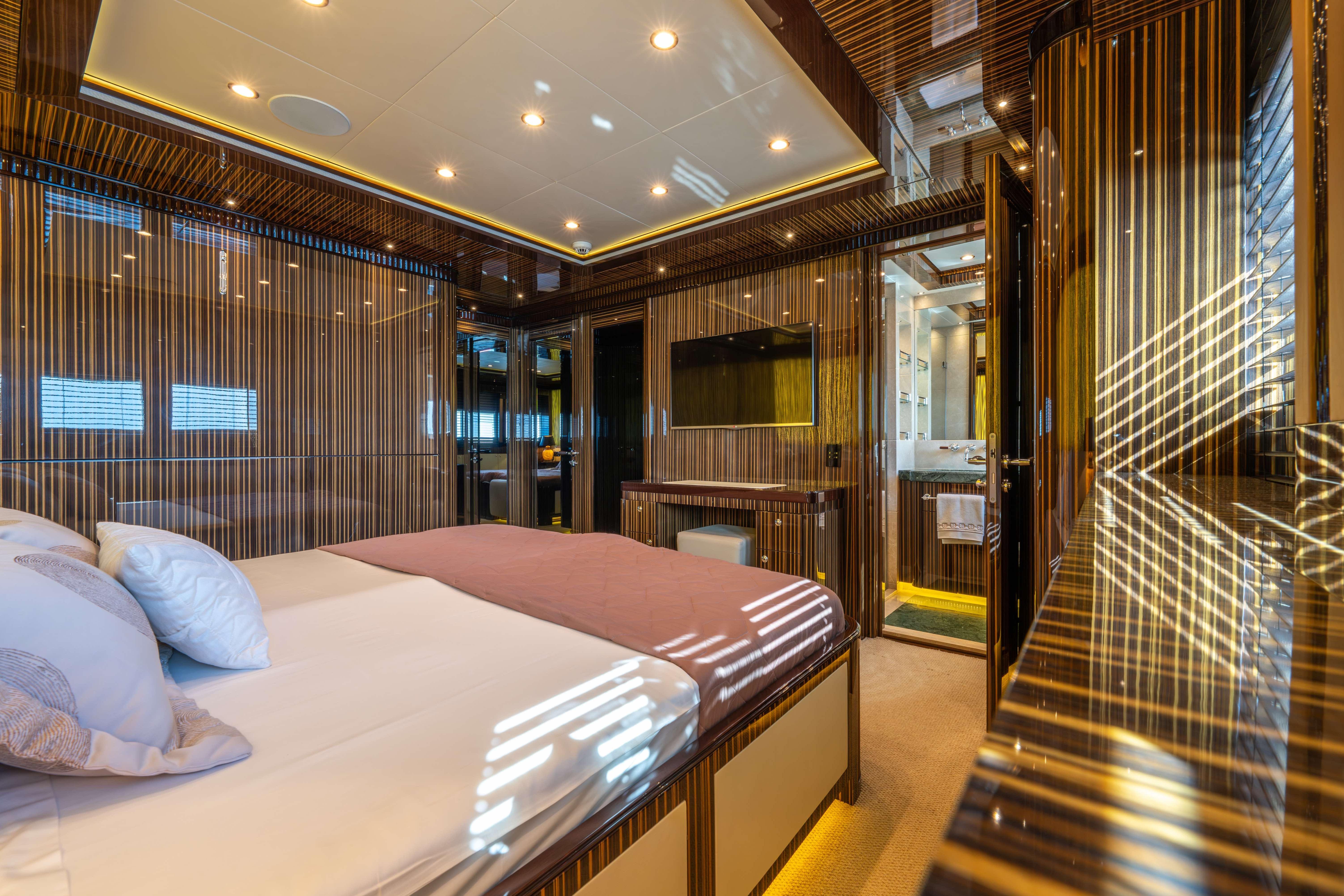 Luxurious bedroom interior of 2014 Bilgin 147 yacht with elegant wood paneling.