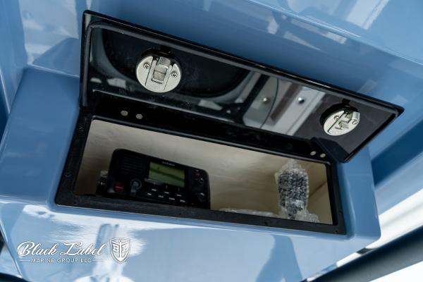Storage compartment in 2025 Caymas 281 HB boat with electronic equipment.