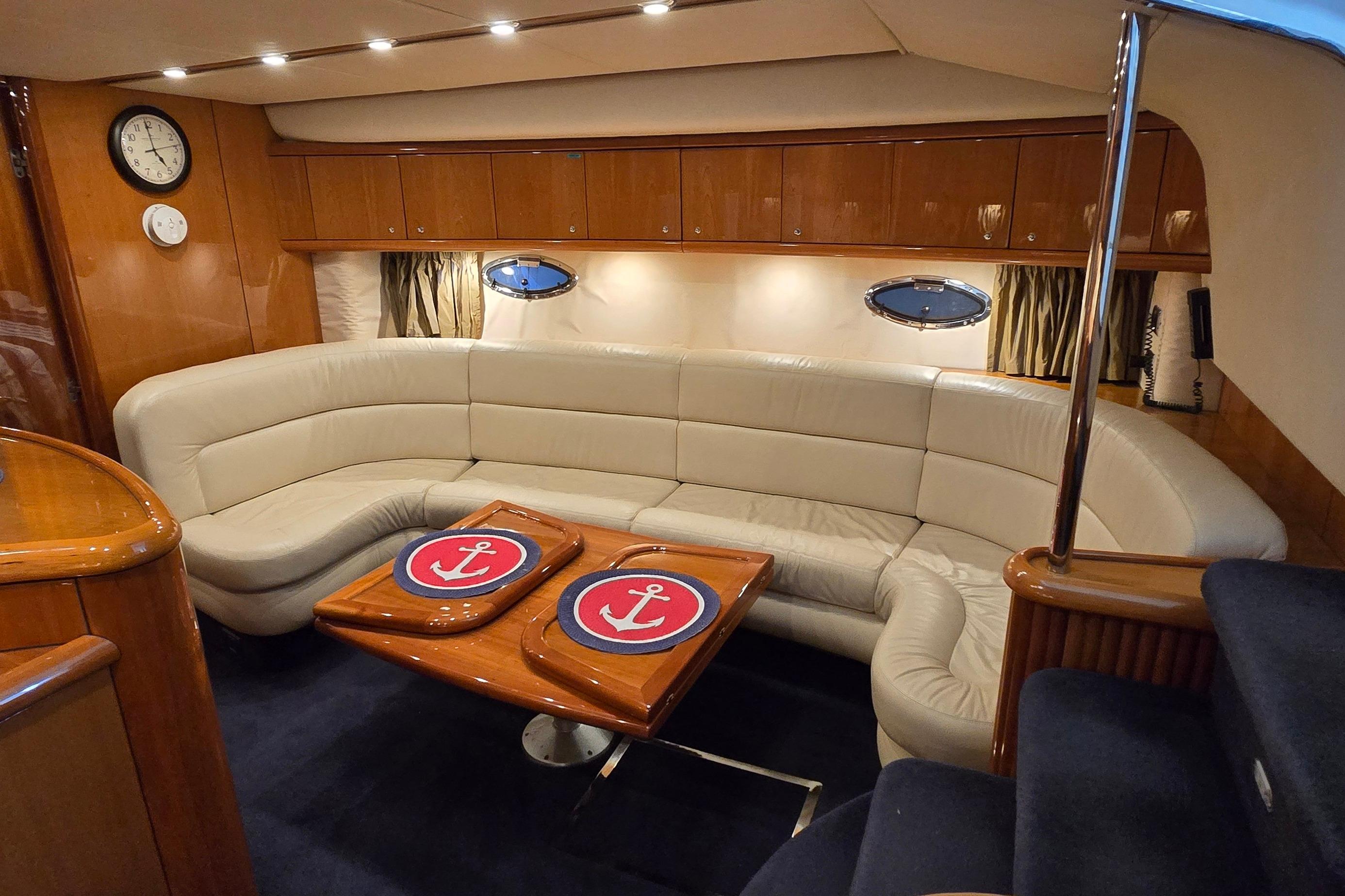 Luxurious interior of 2004 Sunseeker Camargue 50 yacht with elegant seating and nautical decor.