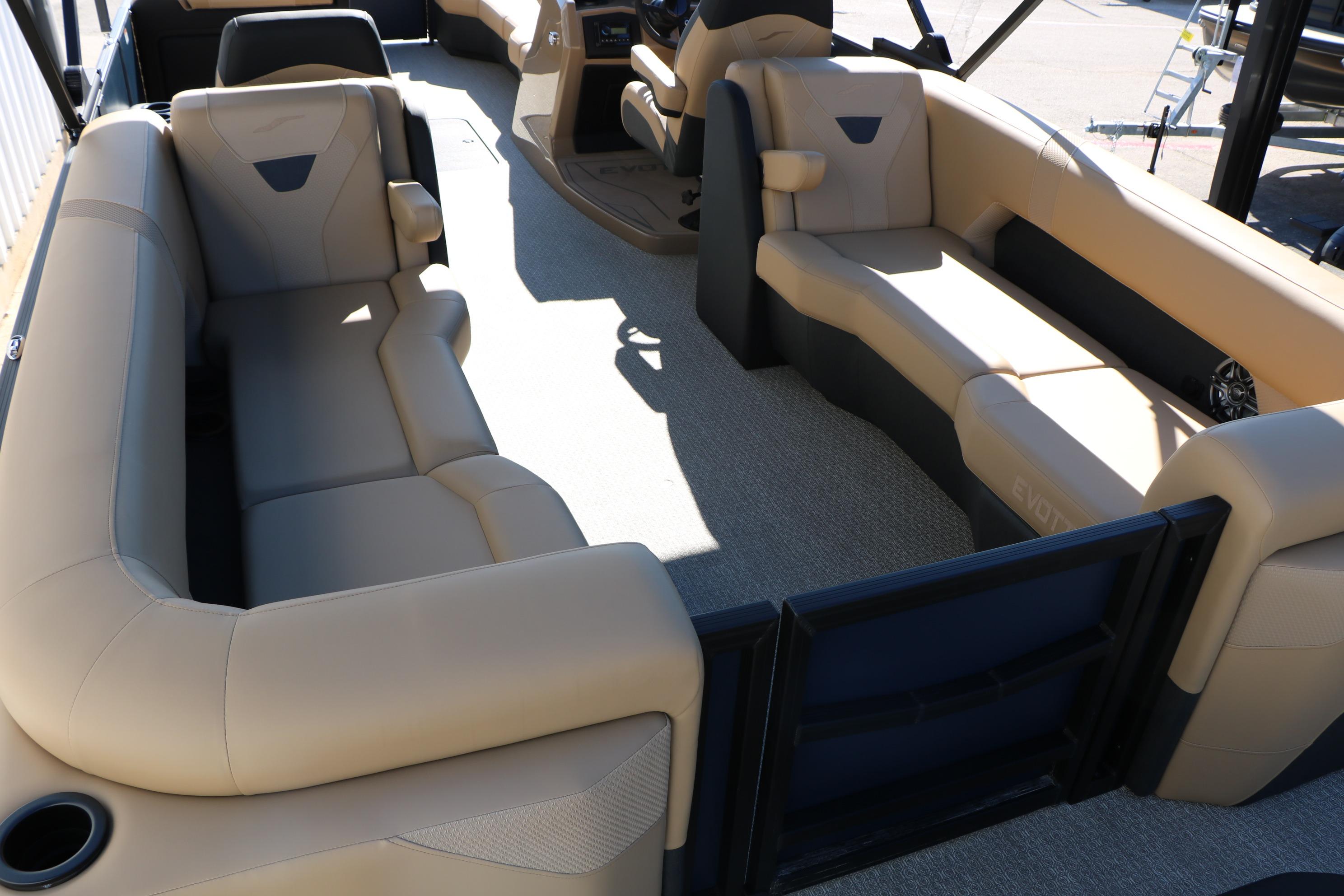Luxurious interior of 2026 Evotti 525 QL Tri-Toon with beige seating and spacious layout.