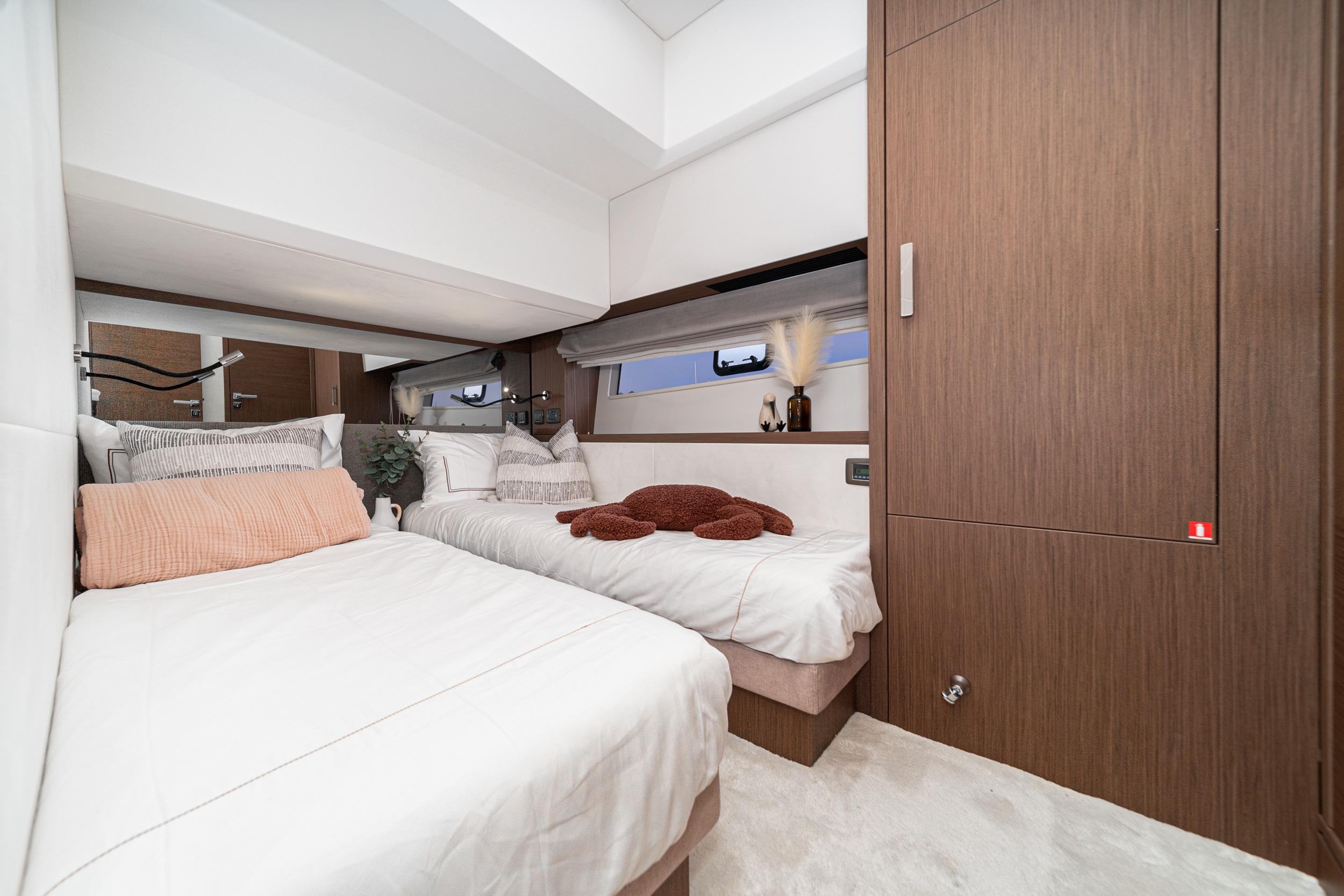 Luxurious twin bedroom in 2024 Prestige X60 yacht, featuring modern design and cozy decor.