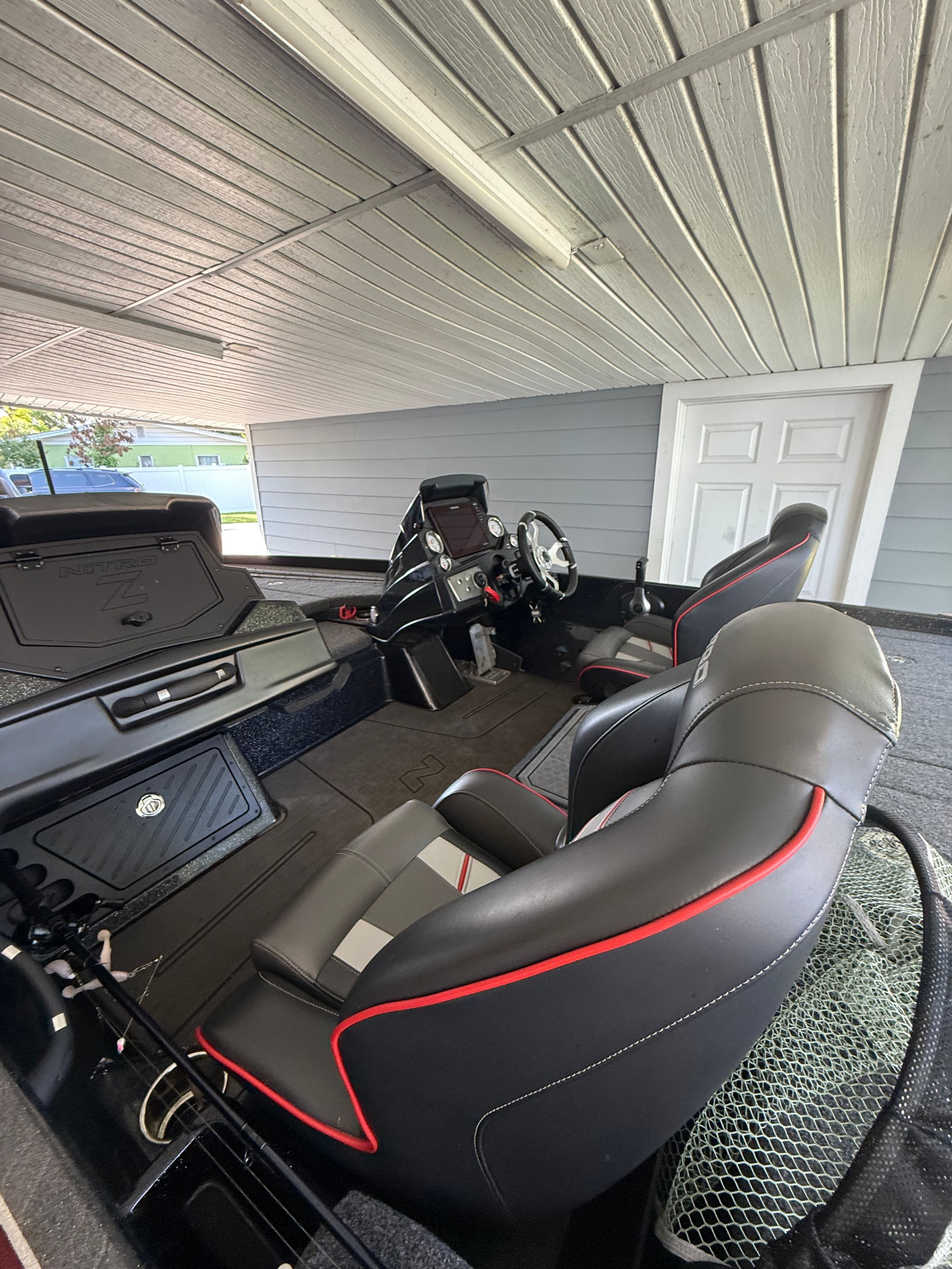 The image shows the interior of a 2024 Nitra Boats 21 XL Pro with modern seating and controls.