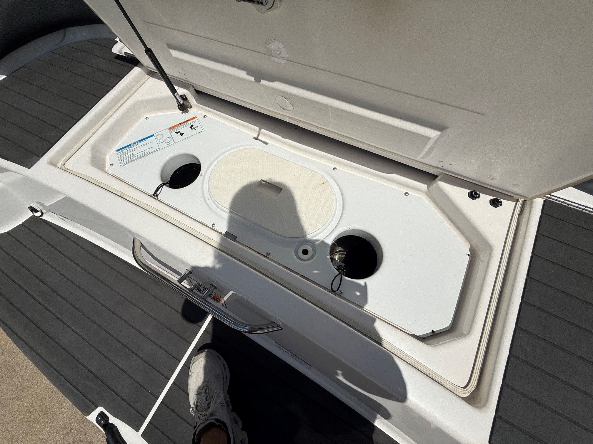 An open storage compartment on a Yamaha SX210 boat.