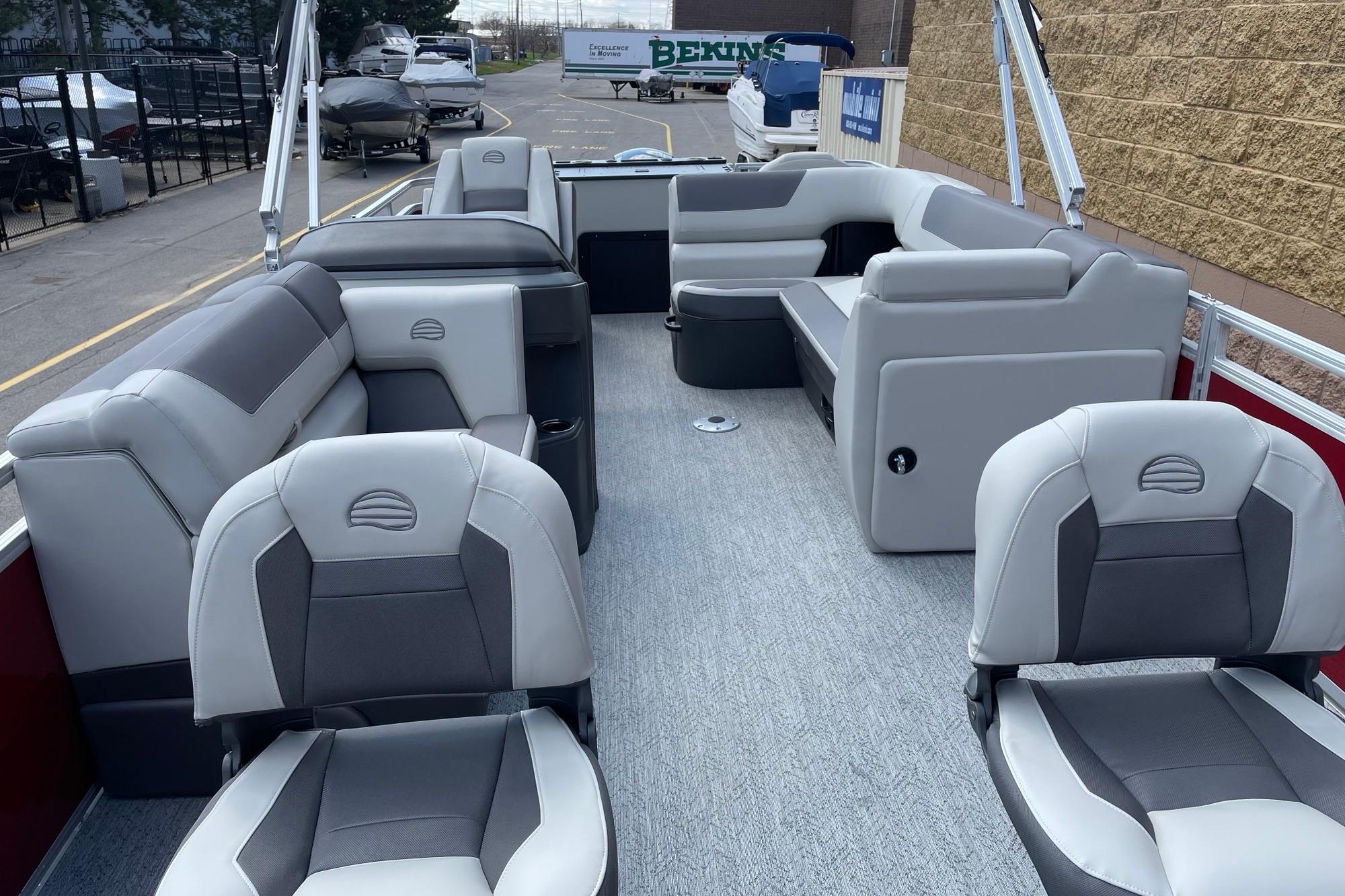 2026 Sun Tracker Fishin' Barge 22 DLX interior with gray seating and spacious layout.