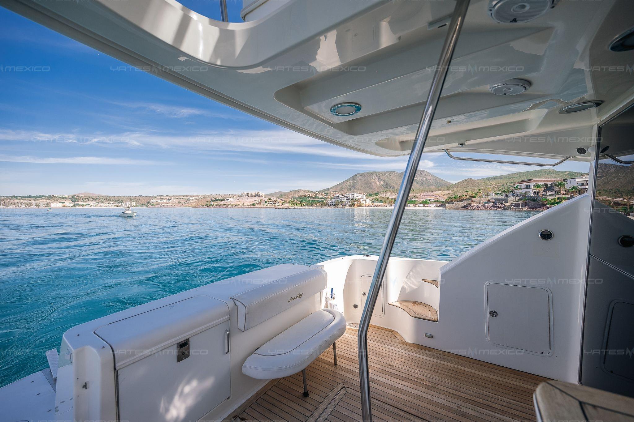 2008 Sea Ray 480 Sedan Bridge yacht with scenic coastal view and clear blue waters.