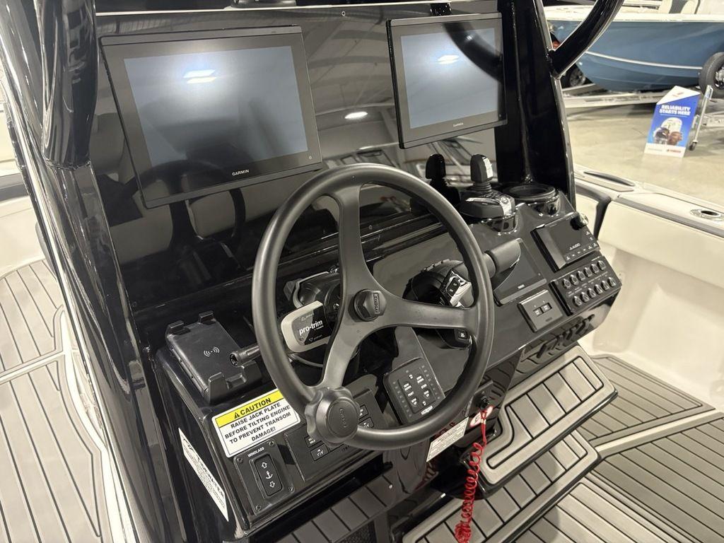 2026 Tidewater 2700 CB boat dashboard with dual screens and steering wheel.