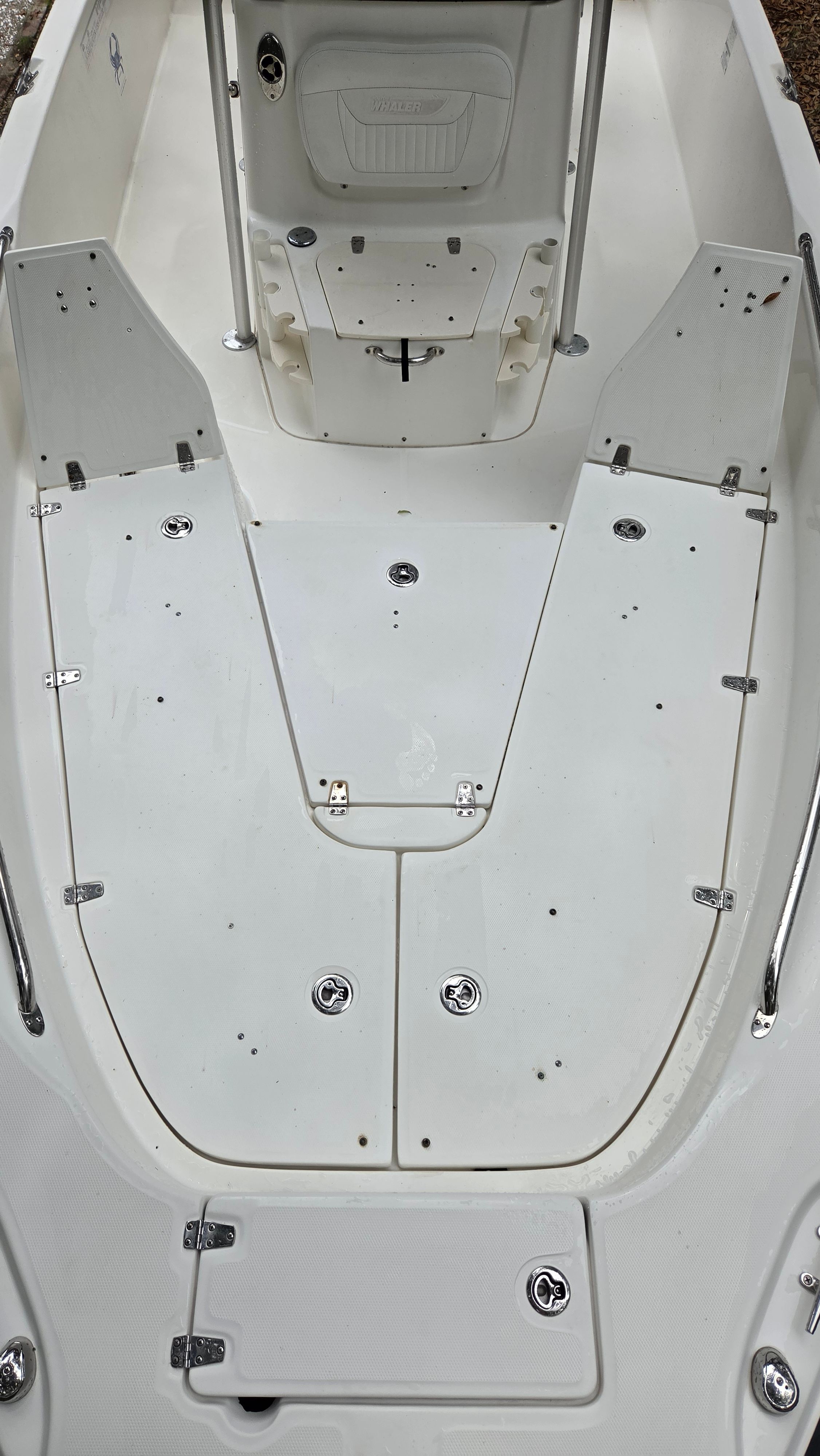 The image shows the deck of a 2008 Boston Whaler 230 Dauntless with storage hatches.