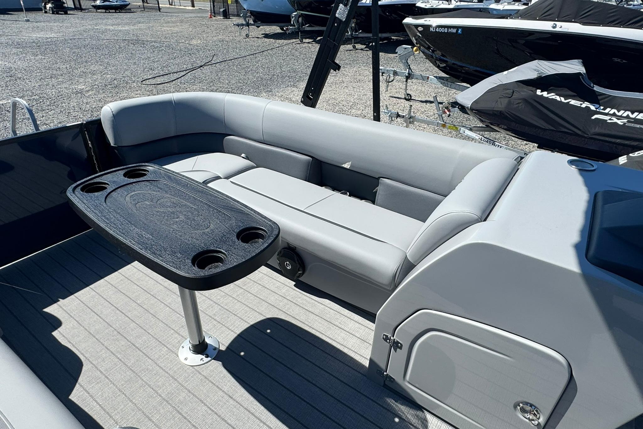 2026 Bentley Pontoons Legacy 243 Swingback interior with seating and table, showcasing luxury design.