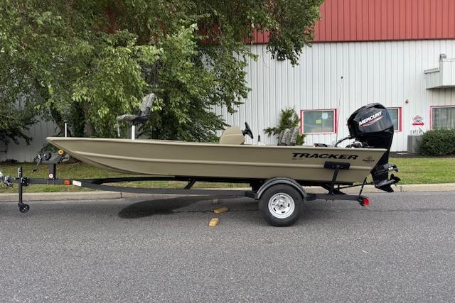 2026 Tracker Grizzly 1754 SC boat on trailer, parked outdoors.