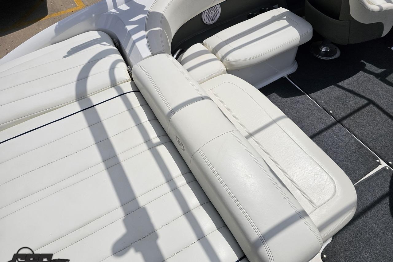2010 Cobalt 232 WSS boat interior with white leather seating and carpeted flooring.