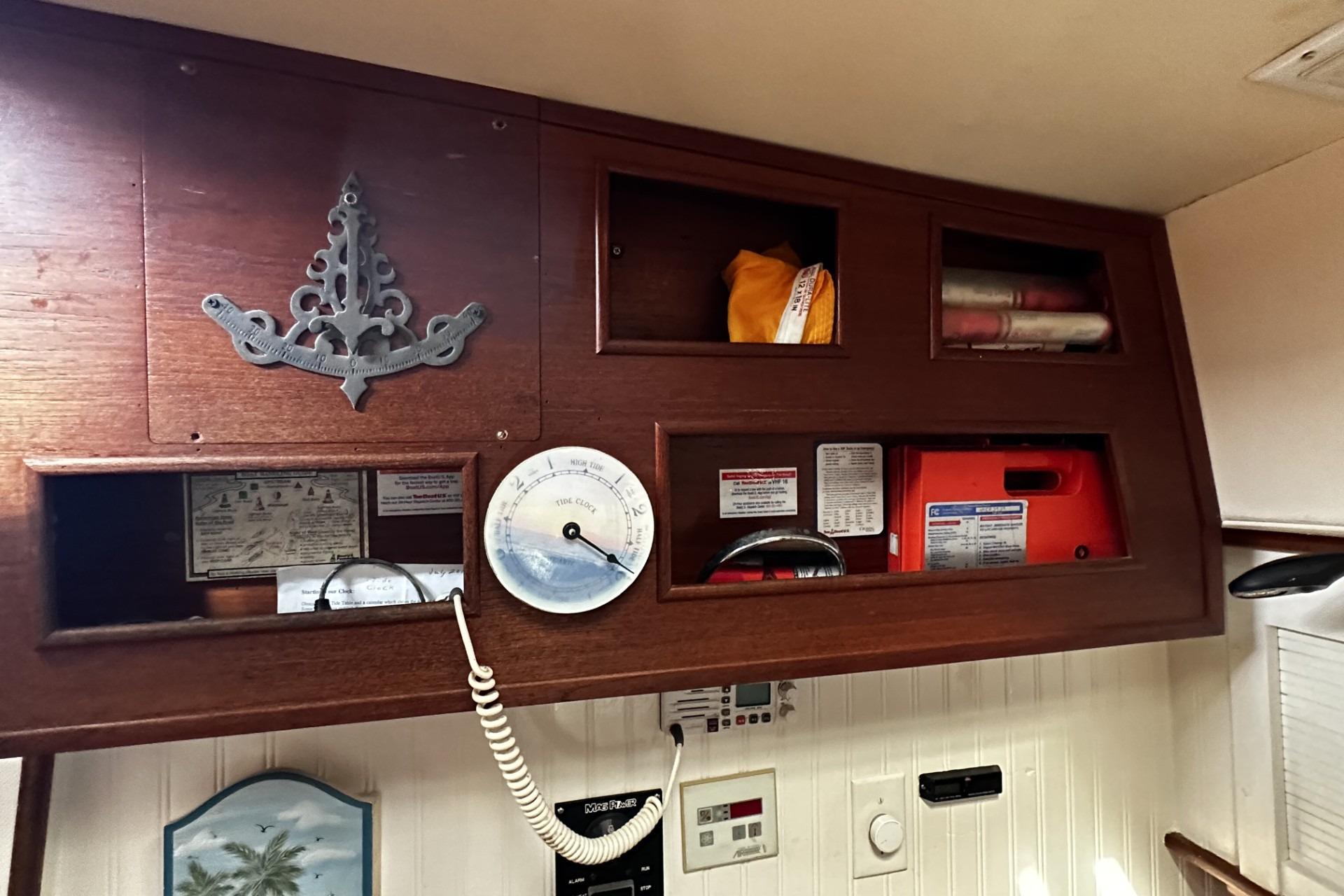 1975 Morgan Out Island 51 interior with wooden storage, gauge, and nautical decor.