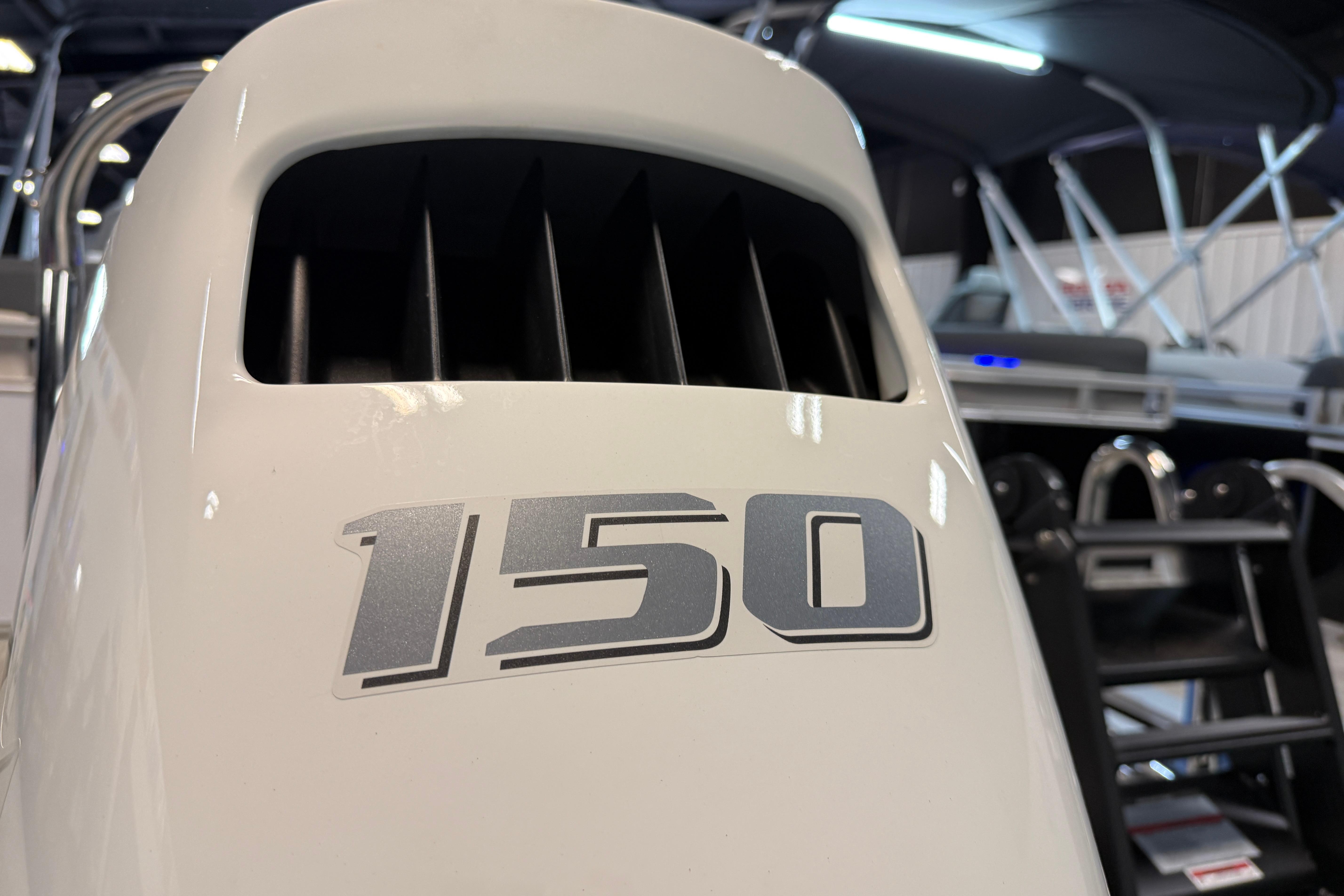 Close-up of a 150 horsepower engine on a 2026 Tahoe Pontoon LTZ Quad Lounger.