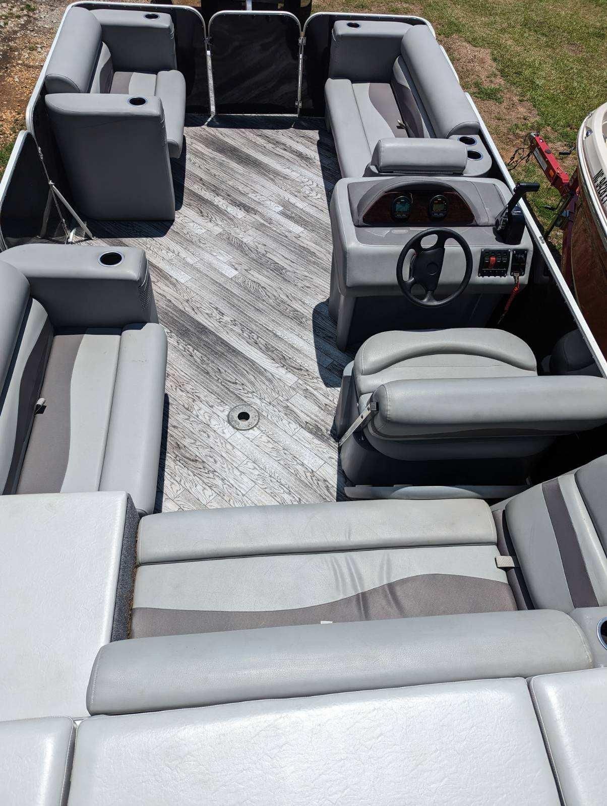 Interior view of a 2022 Crest Pontoon boat with gray seating.