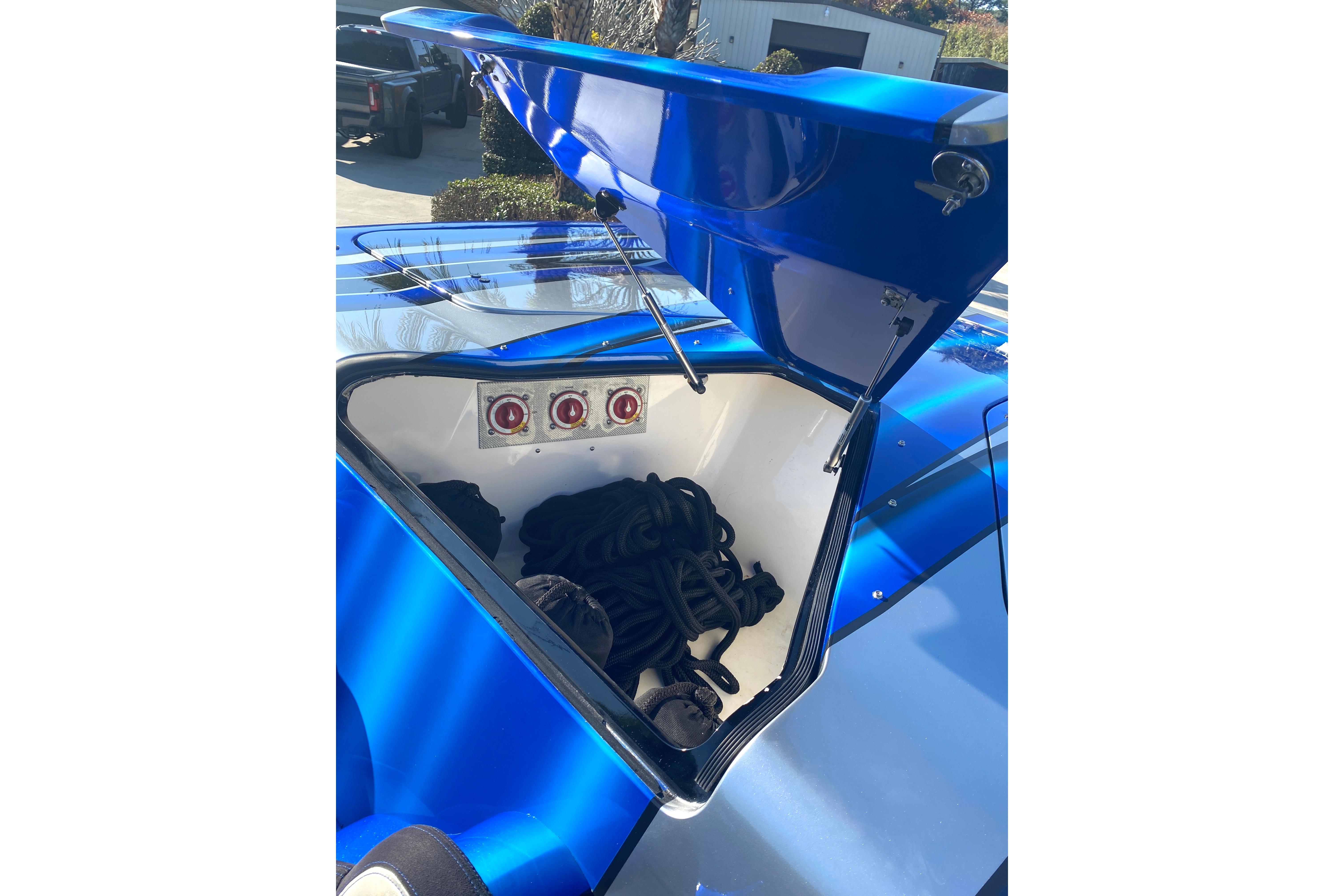 Open storage compartment on a 2016 MTI 44 RP boat, showing ropes and equipment.