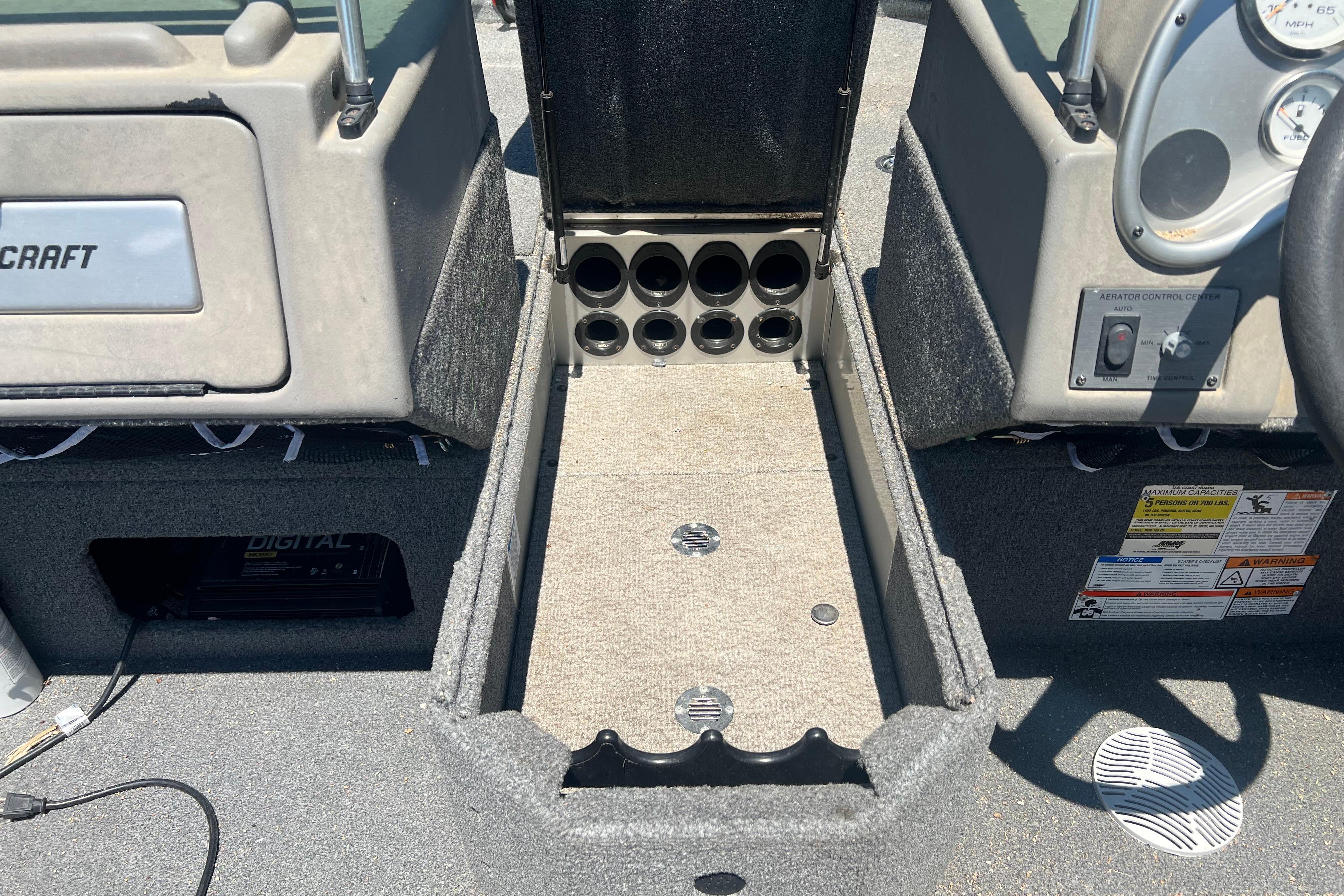 2010 Alumacraft Dominator 165 Sport interior with storage compartments and control panel.