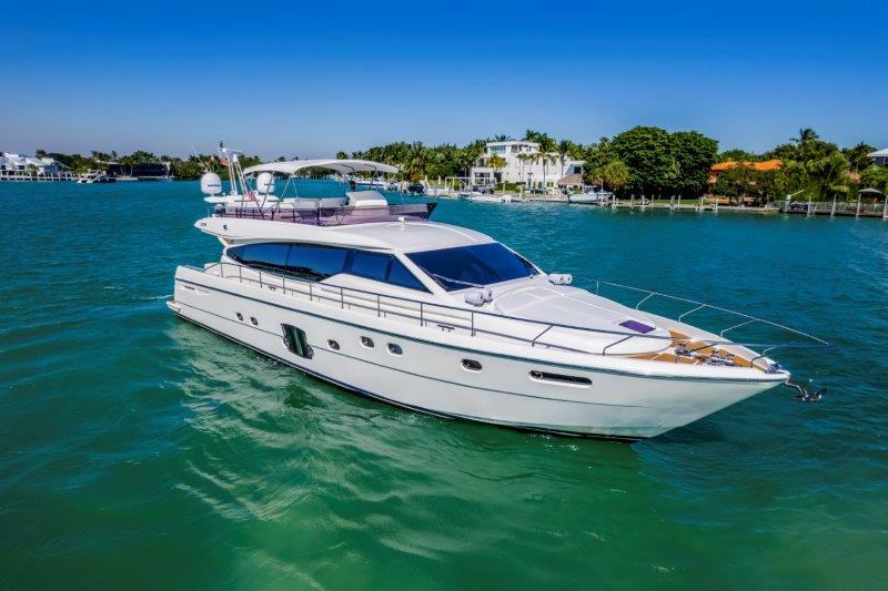 Luxurious 2011 Ferretti Yachts 660 cruising on turquoise waters under clear blue skies.