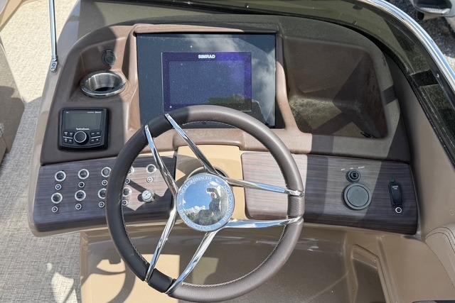2021 Bennington QX 25 QXSBWA boat dashboard with steering wheel and control panel.