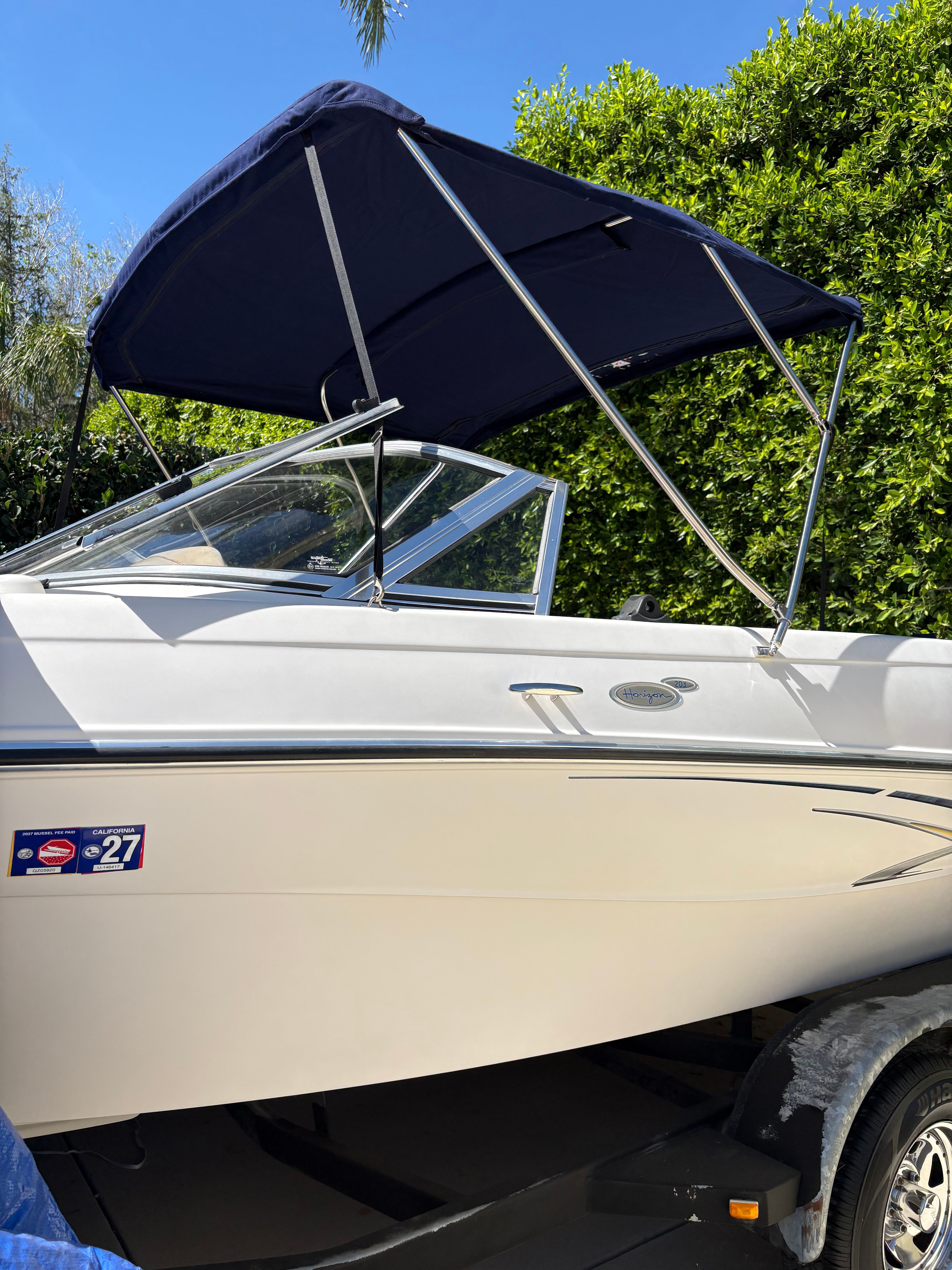 2007 Four Winns 203 Horizon boat with canopy, side view.