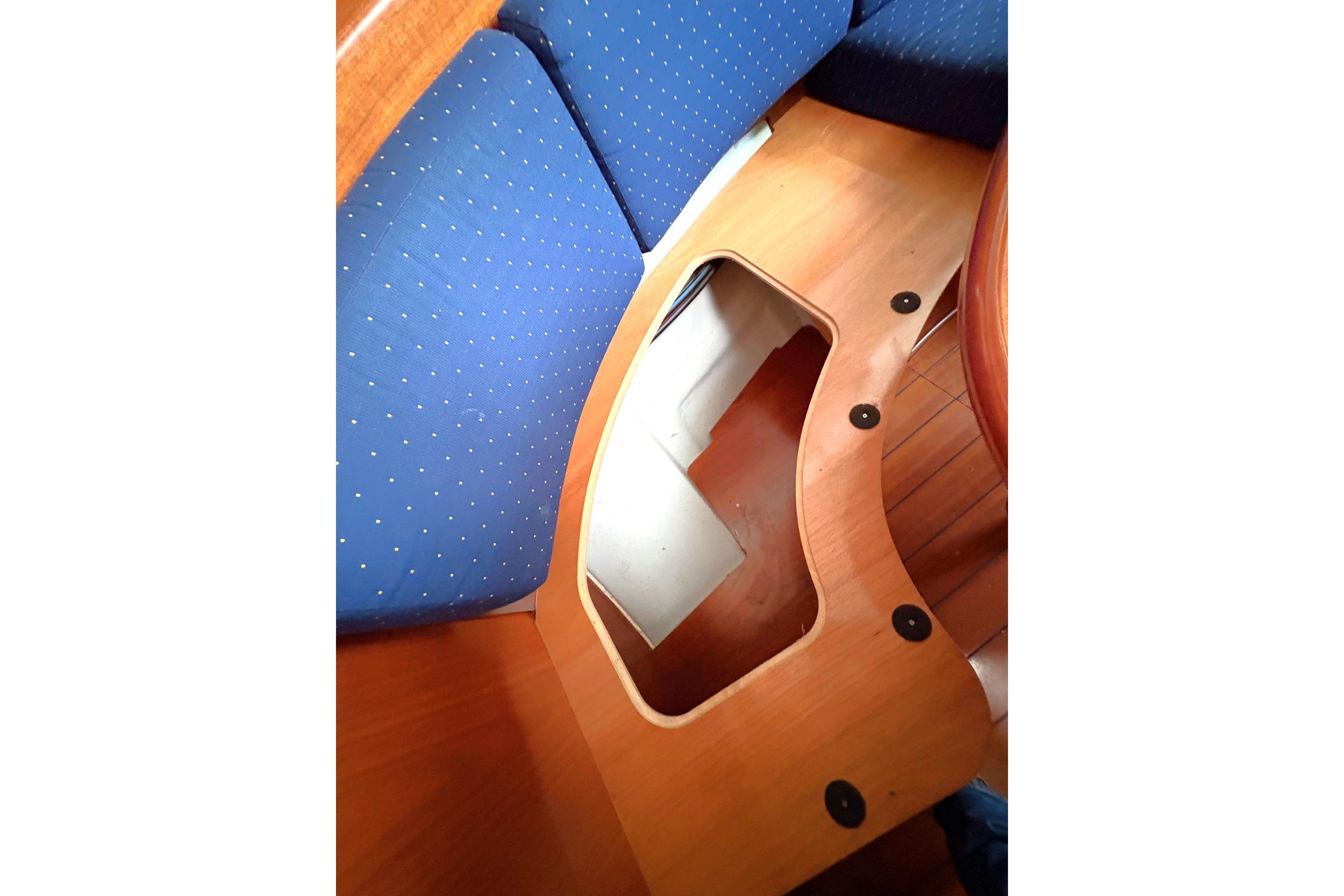 Interior view of 2005 Beneteau First 47.7 sailboat with blue cushioned seating.