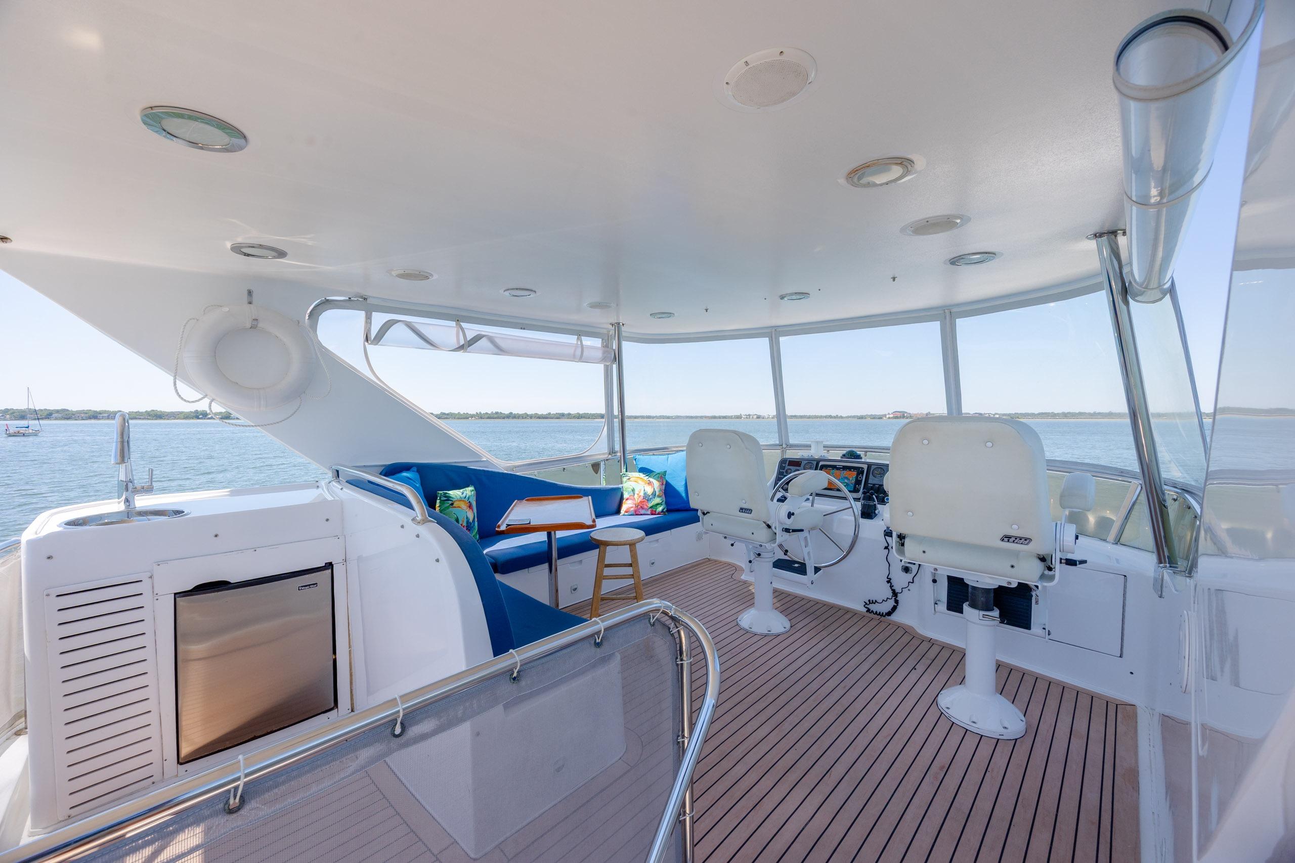 Luxurious 2005 Ocean Alexander 52 Sedan yacht interior with helm, seating, and ocean view.