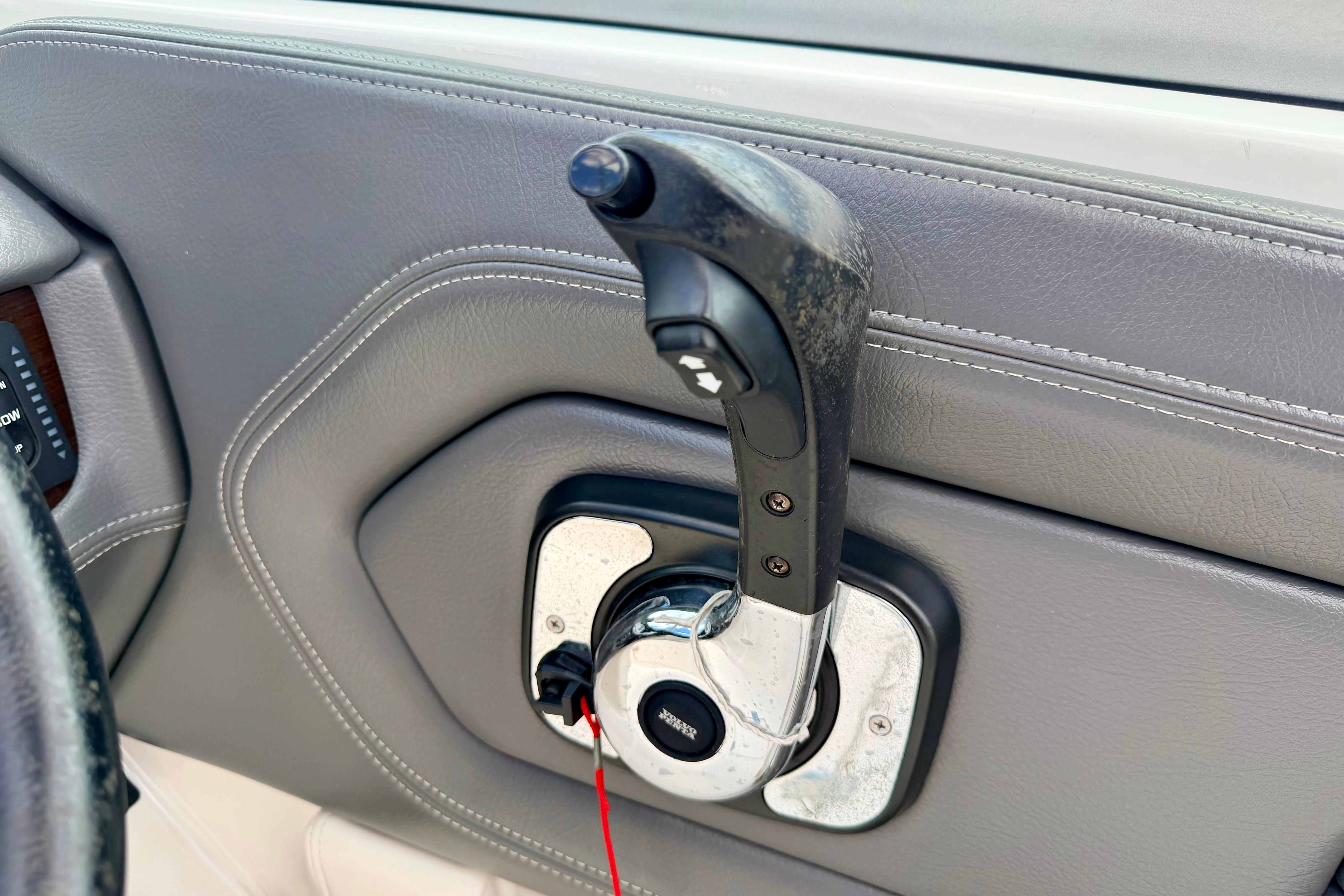 2015 Chaparral Sunesta 264 throttle control lever on gray interior panel.