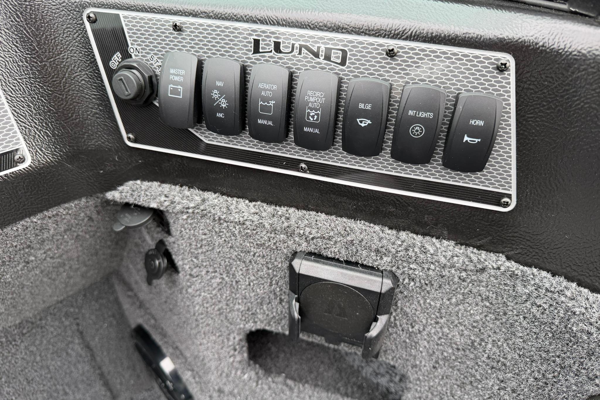 Control panel of 2027 Lund 2075 Impact XS boat with various switches.