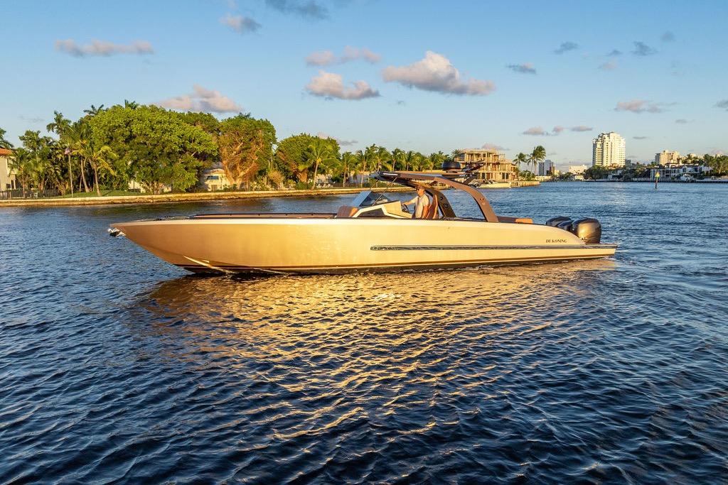 Luxury DeKoning 43 boat cruising on a sunny day, 2023 model.