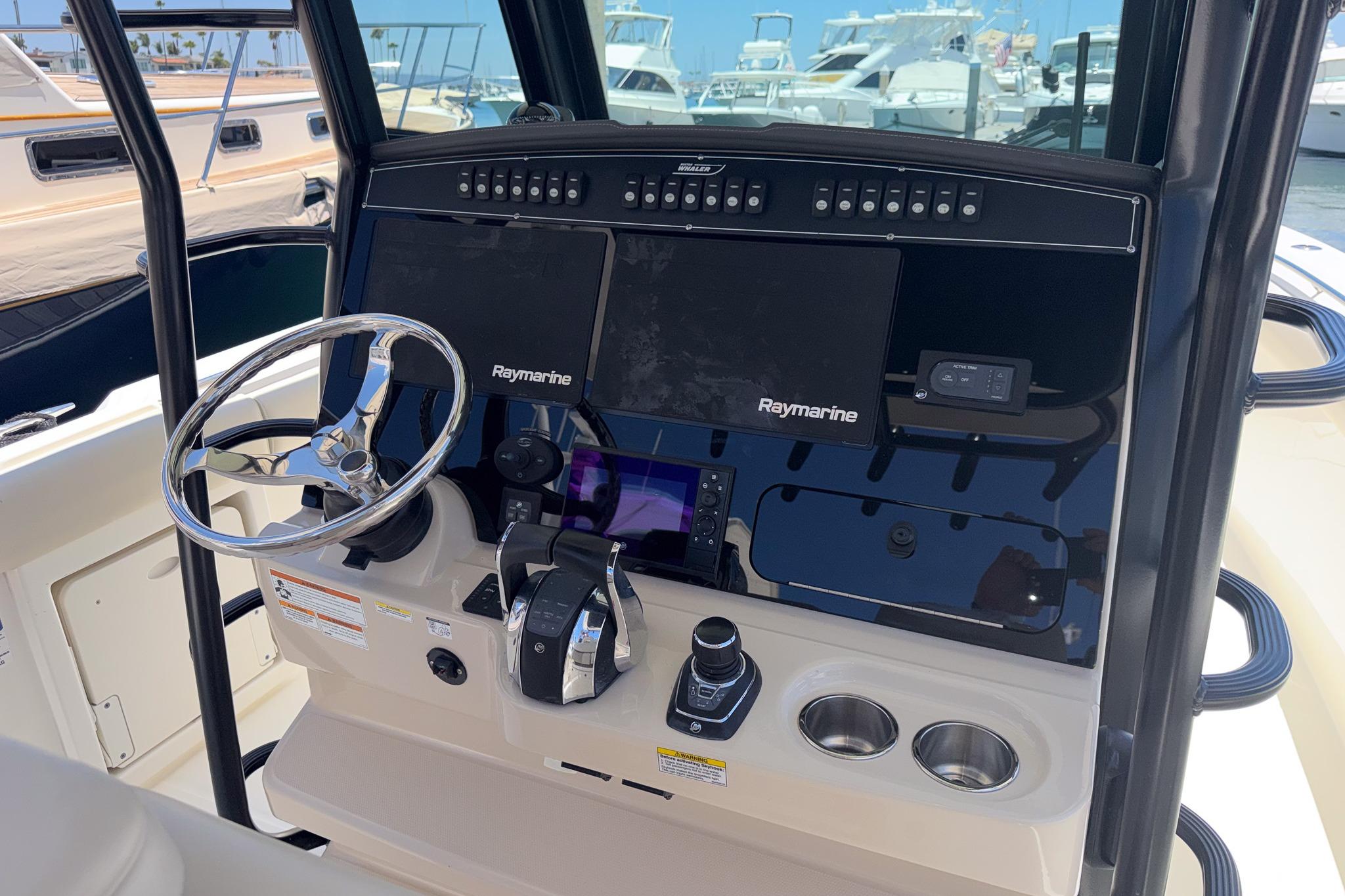 2021 Boston Whaler 330 Outrage helm with Raymarine electronics and modern controls.