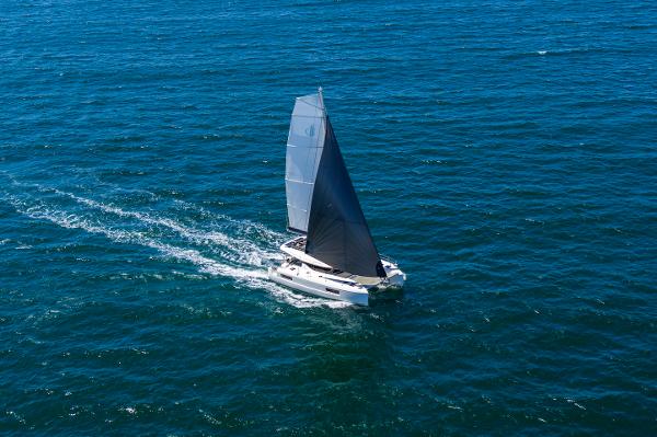 2025 Lagoon 43 catamaran sailing on open ocean waters.