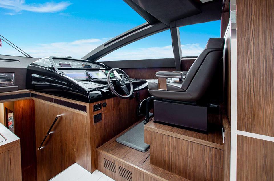 2017 Riva 88 Domino Super yacht helm station with modern controls and luxurious seating.
