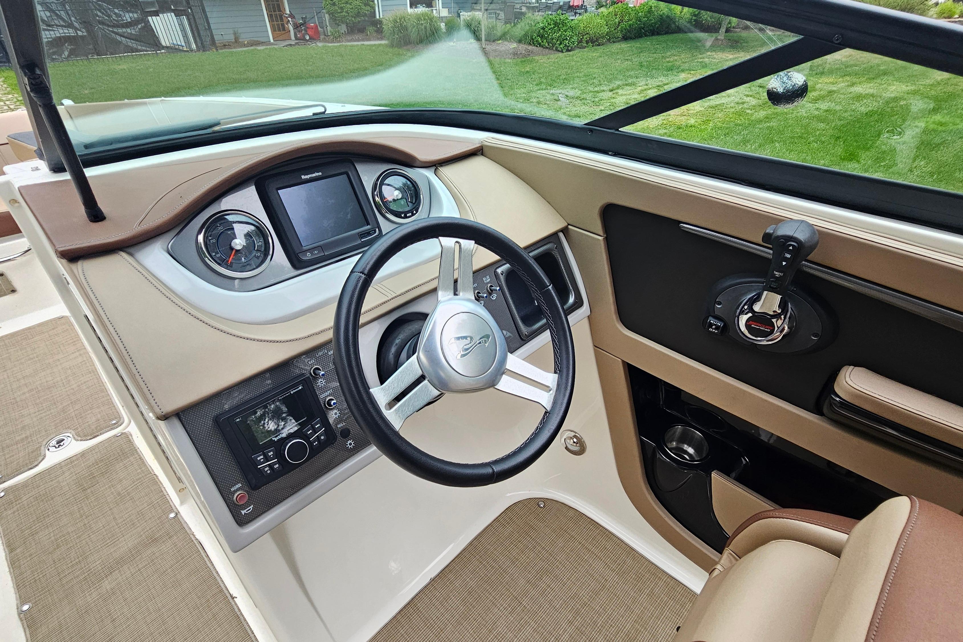 2017 Sea Ray SDX 240 Outboard dashboard with steering wheel and control panel.