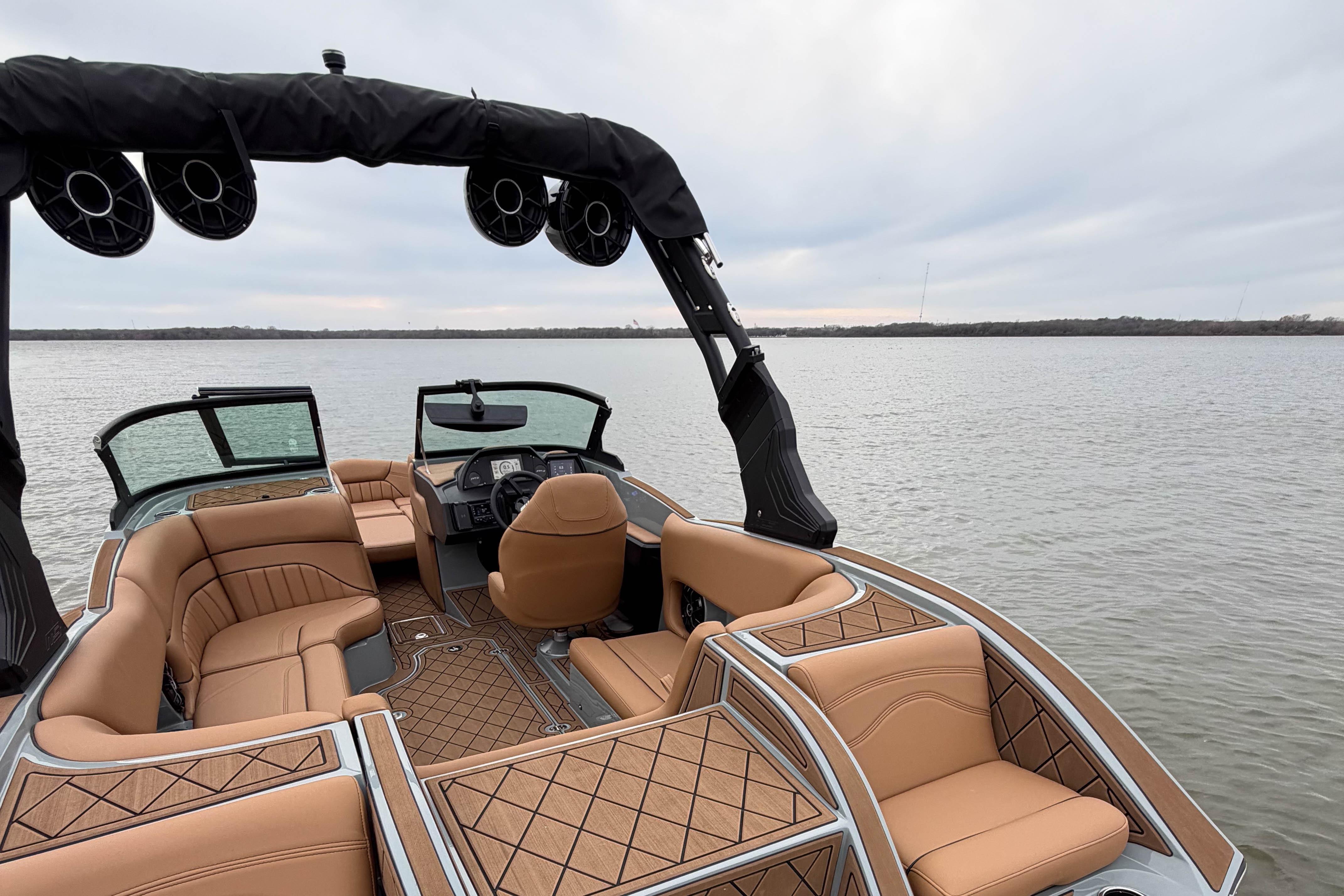 Luxurious 2026 MB B52 21 Alpha boat interior with tan seating on a calm lake.