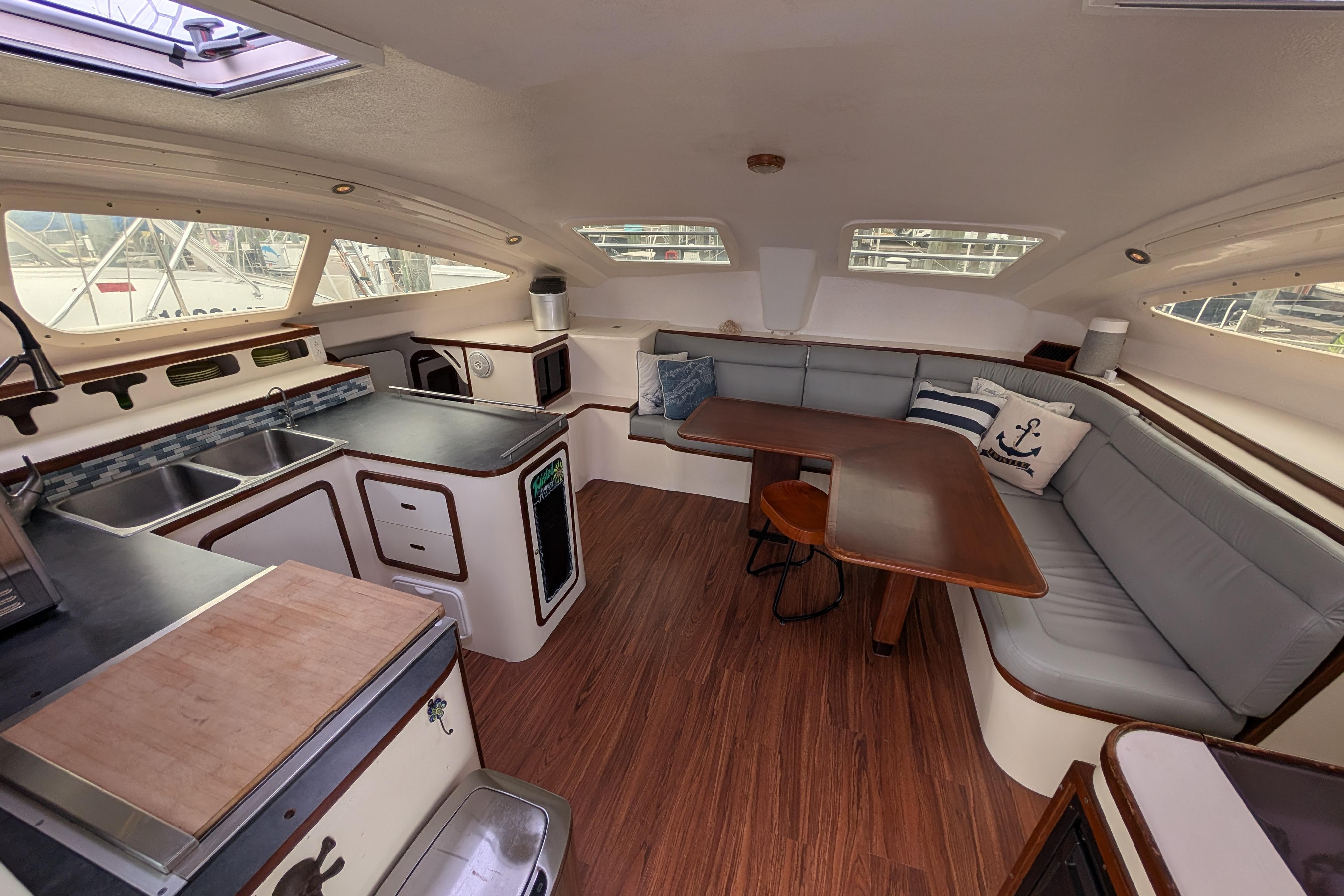 Interior of 1999 Island Spirit 37 yacht with kitchen and seating area.