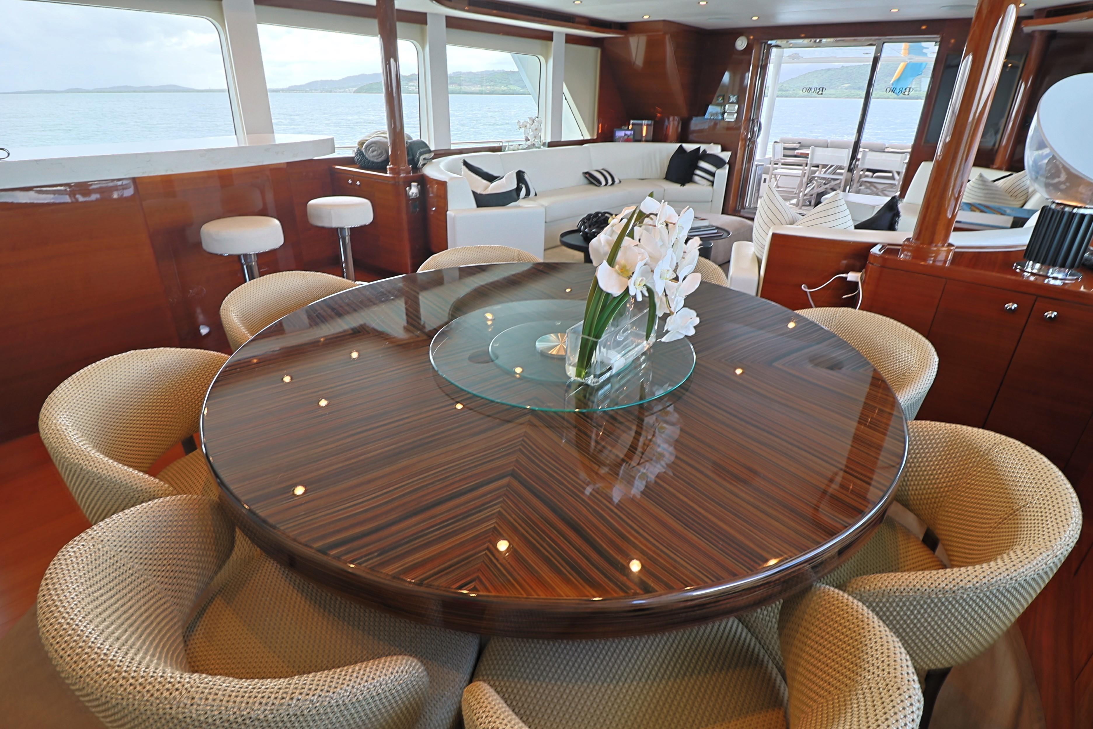 Luxurious interior of 2013 Cheoy Lee Bravo yacht with elegant dining area and ocean view.