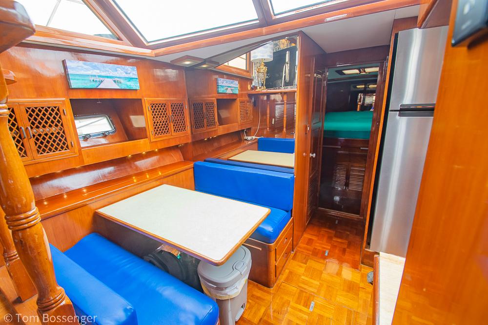 Interior of 1987 Lien Hwa 47 Elegant MKII Motoryacht with wood finish and blue seating.