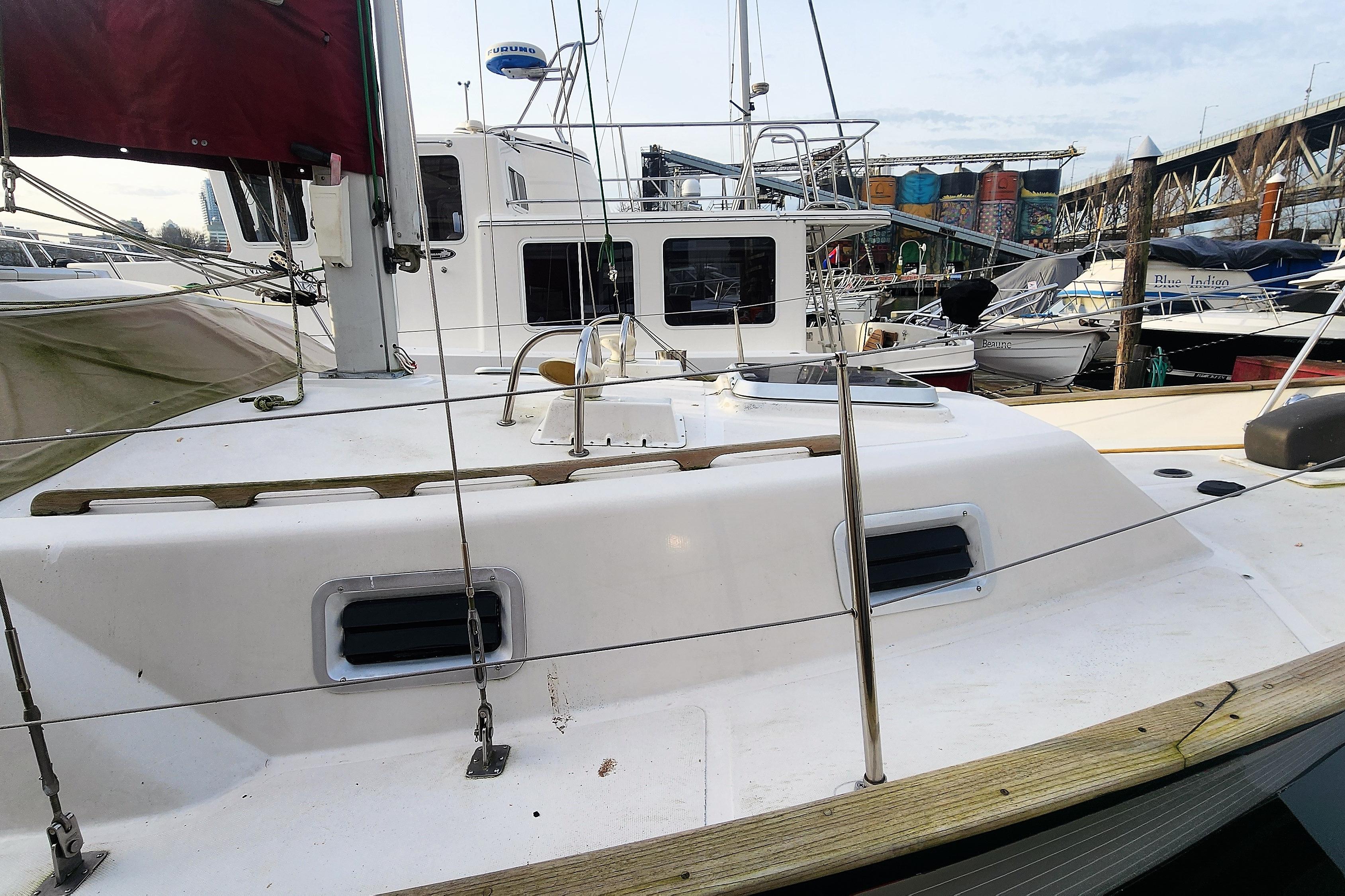 1986 Saturna 33 Pilot sailboat docked at a marina, showcasing deck and cabin features.