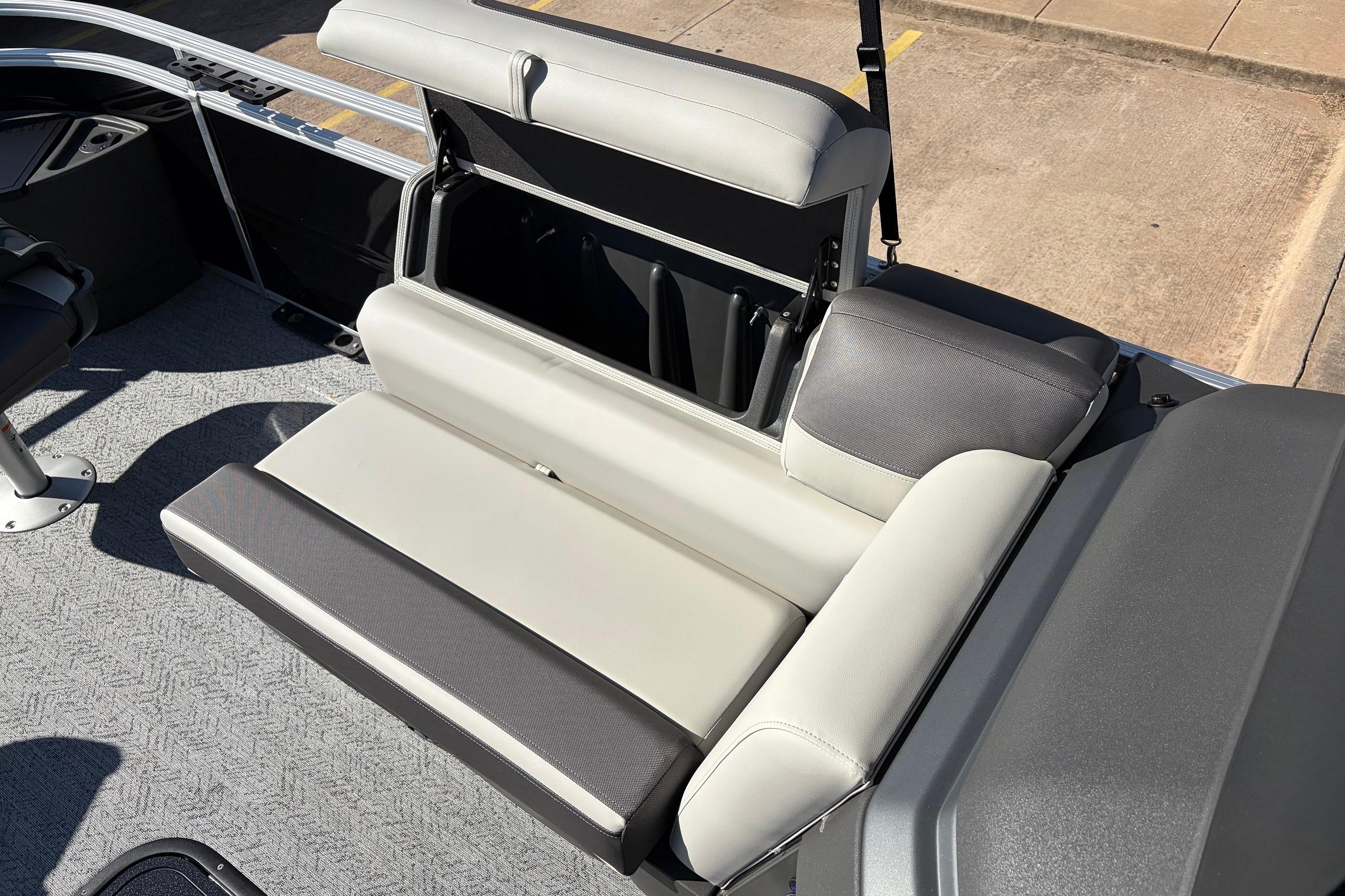 2026 Sun Tracker Fishin' Barge 22 XP3 boat seat with storage compartment open.