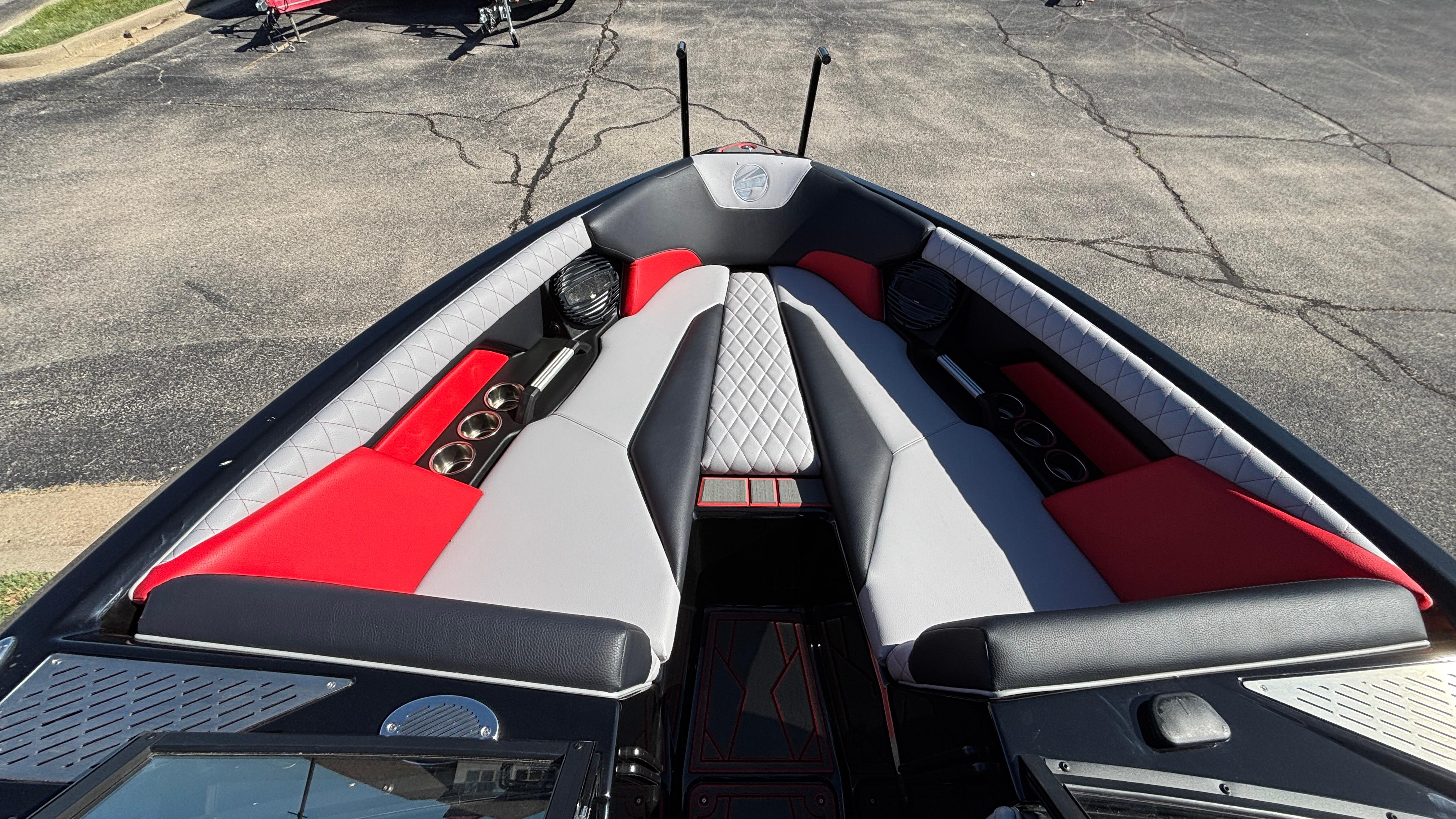 2026 Tigé Z5 boat interior with red and gray seating, cup holders, and speakers.