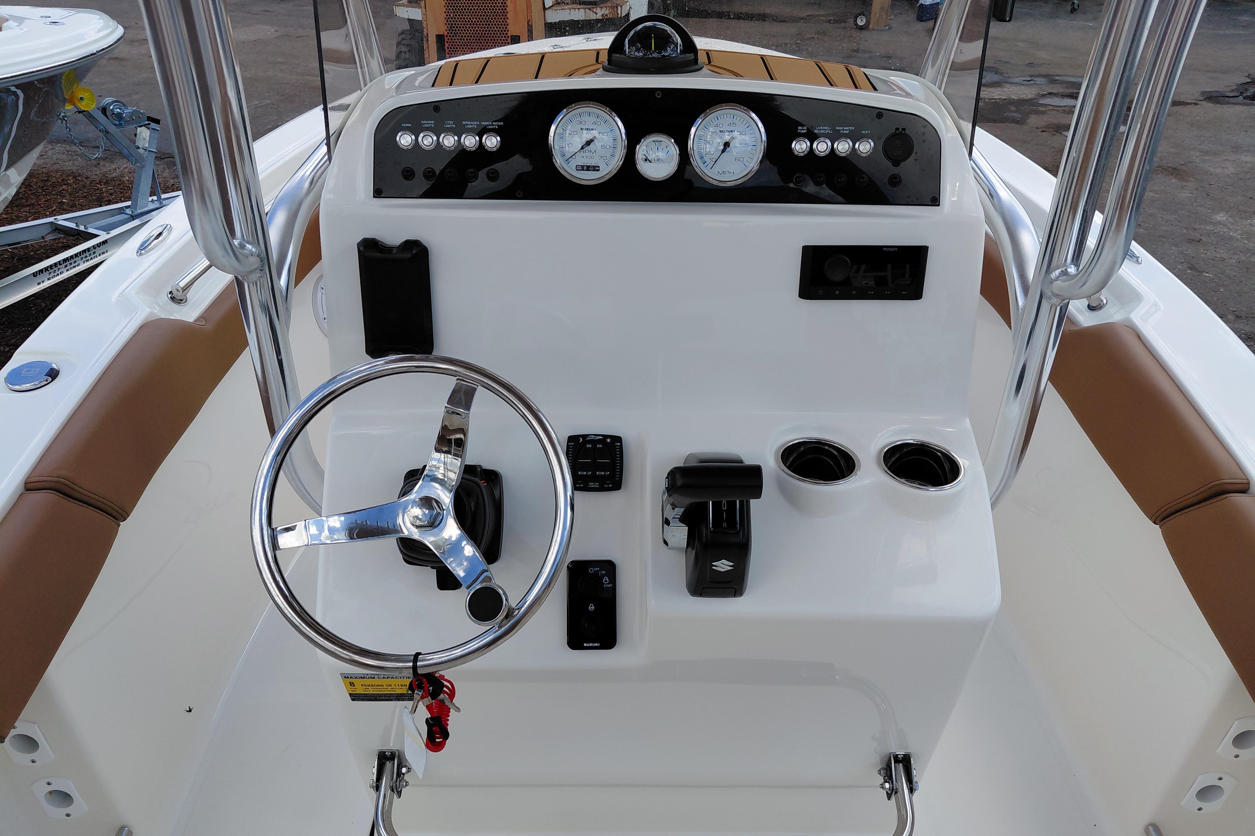 2026 Pioneer 202 Islander boat console with steering wheel, gauges, and controls.