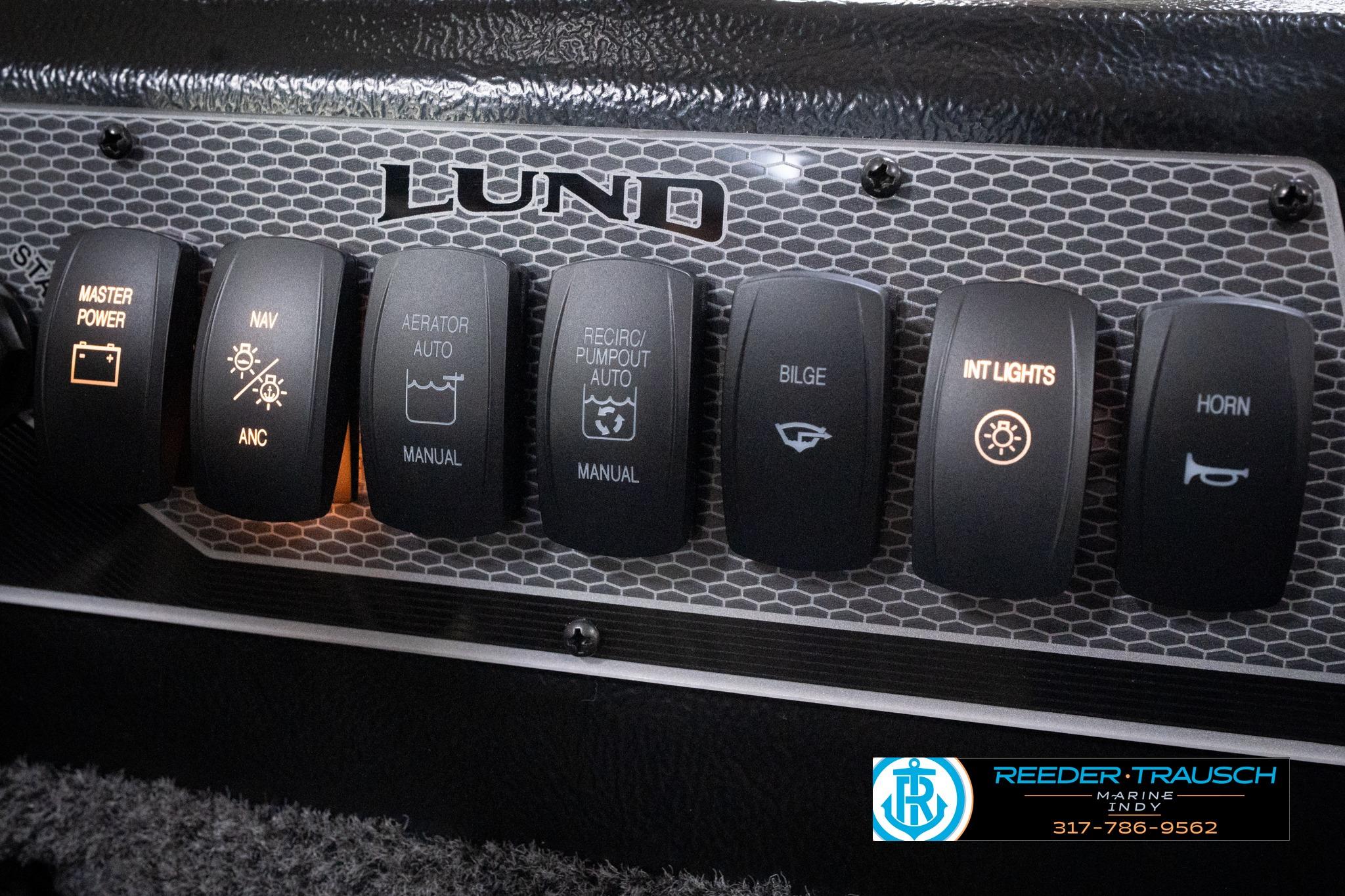 Control panel of 2026 Lund 1775 Impact XS SS boat with labeled switches.