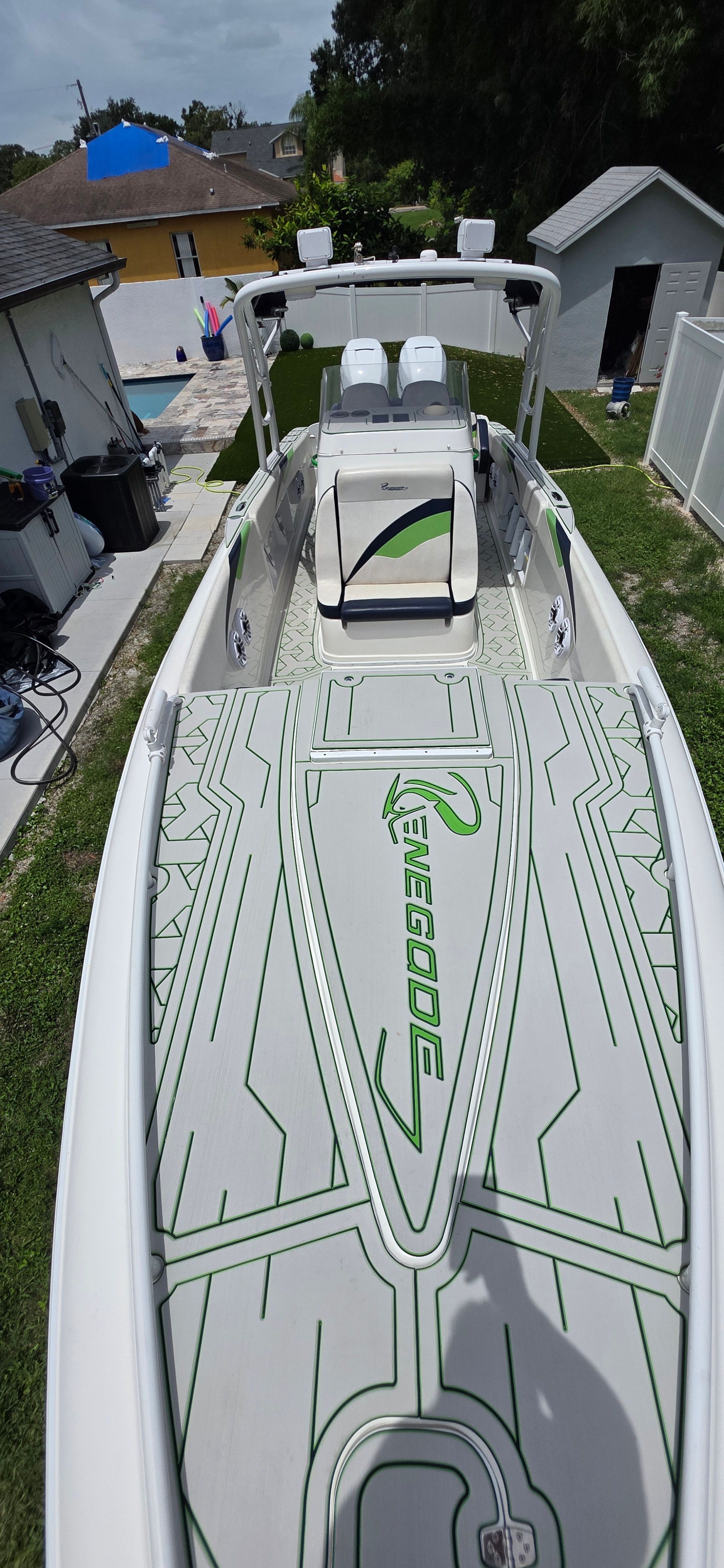 2013 Renegade 32 FT boat with stylish design in backyard.