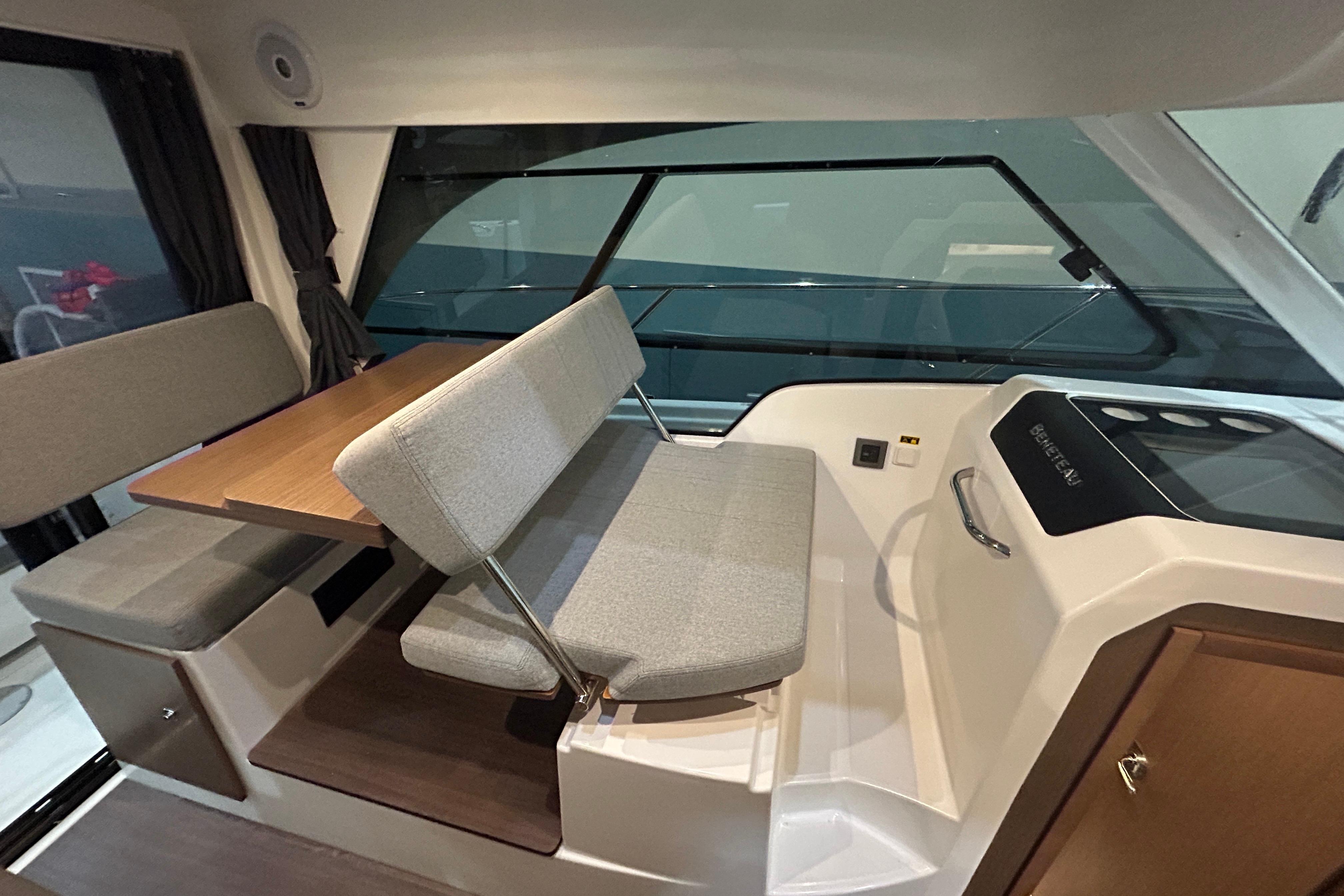 Interior of 2020 Beneteau Antares boat with seating and table arrangement.