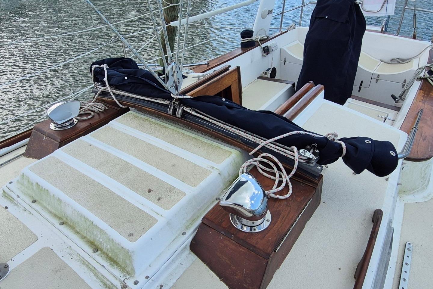 1987 Morgan 384 sailboat deck with rigging and covered equipment.