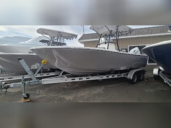 2023 Sea Born LX22 Center Console boat on a trailer, parked outdoors.