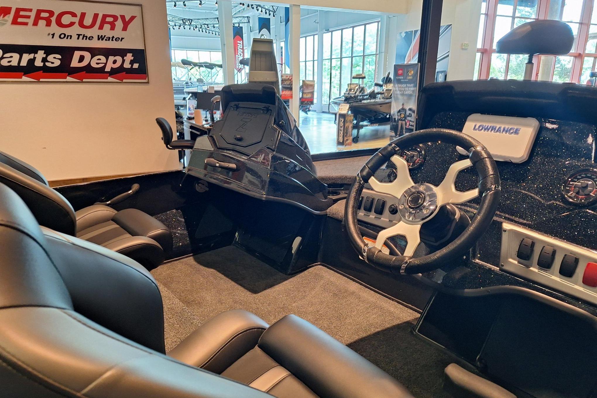 Interior of a 2026 Nitro Z18 boat with steering wheel and control panel.