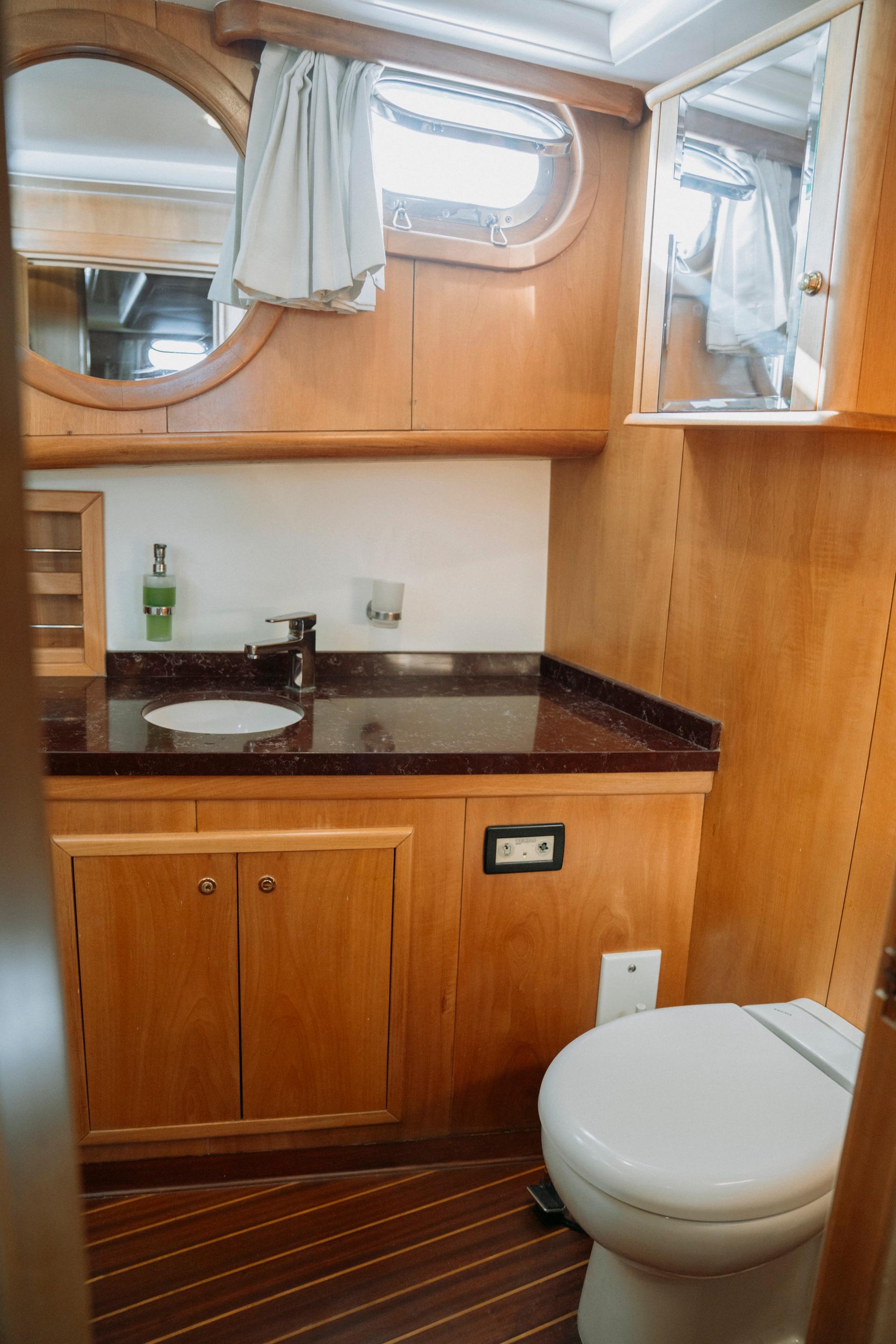 Luxurious bathroom in 2005 custom-made gulet with wooden cabinetry and modern fixtures.