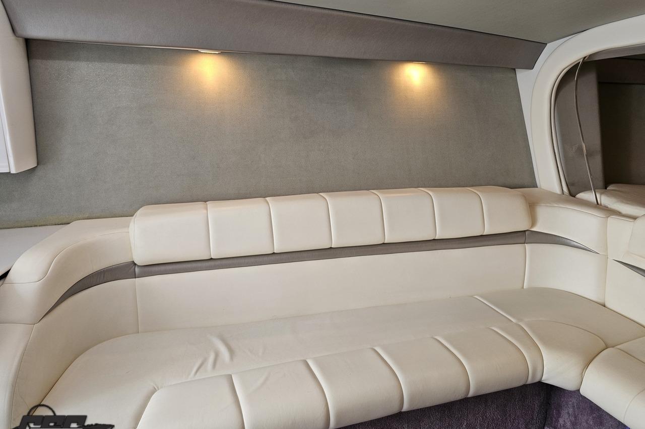 Luxurious interior of a 2002 Formula 382 FASTech boat with plush white seating.