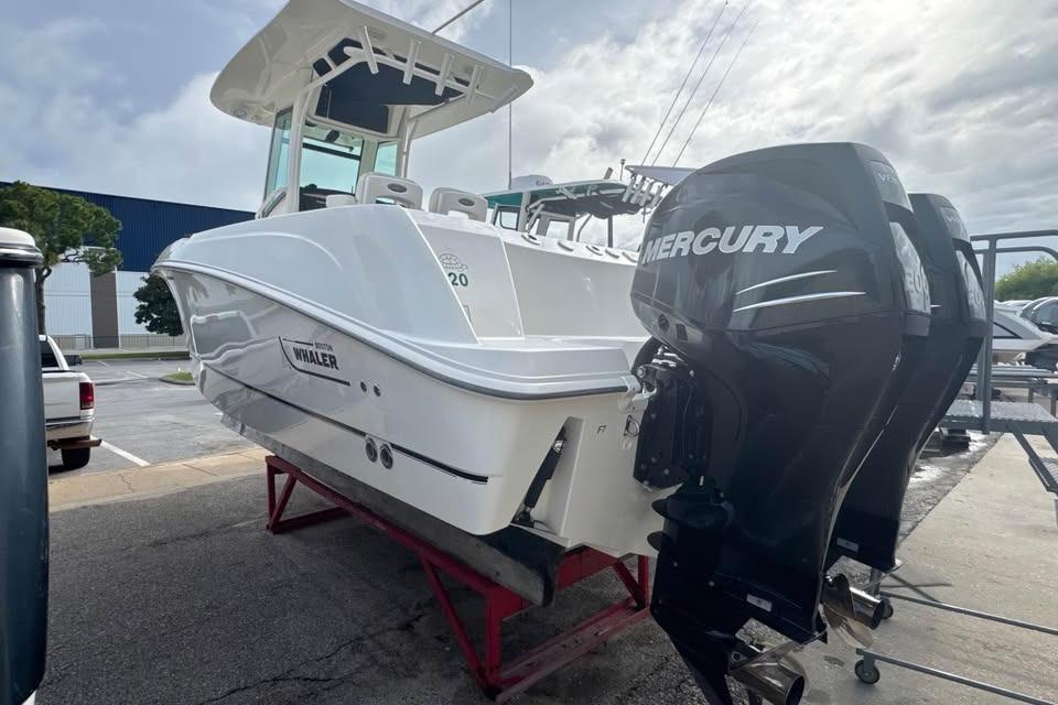 2016 Boston Whaler 250 Outrage boat with dual Mercury engines on display.