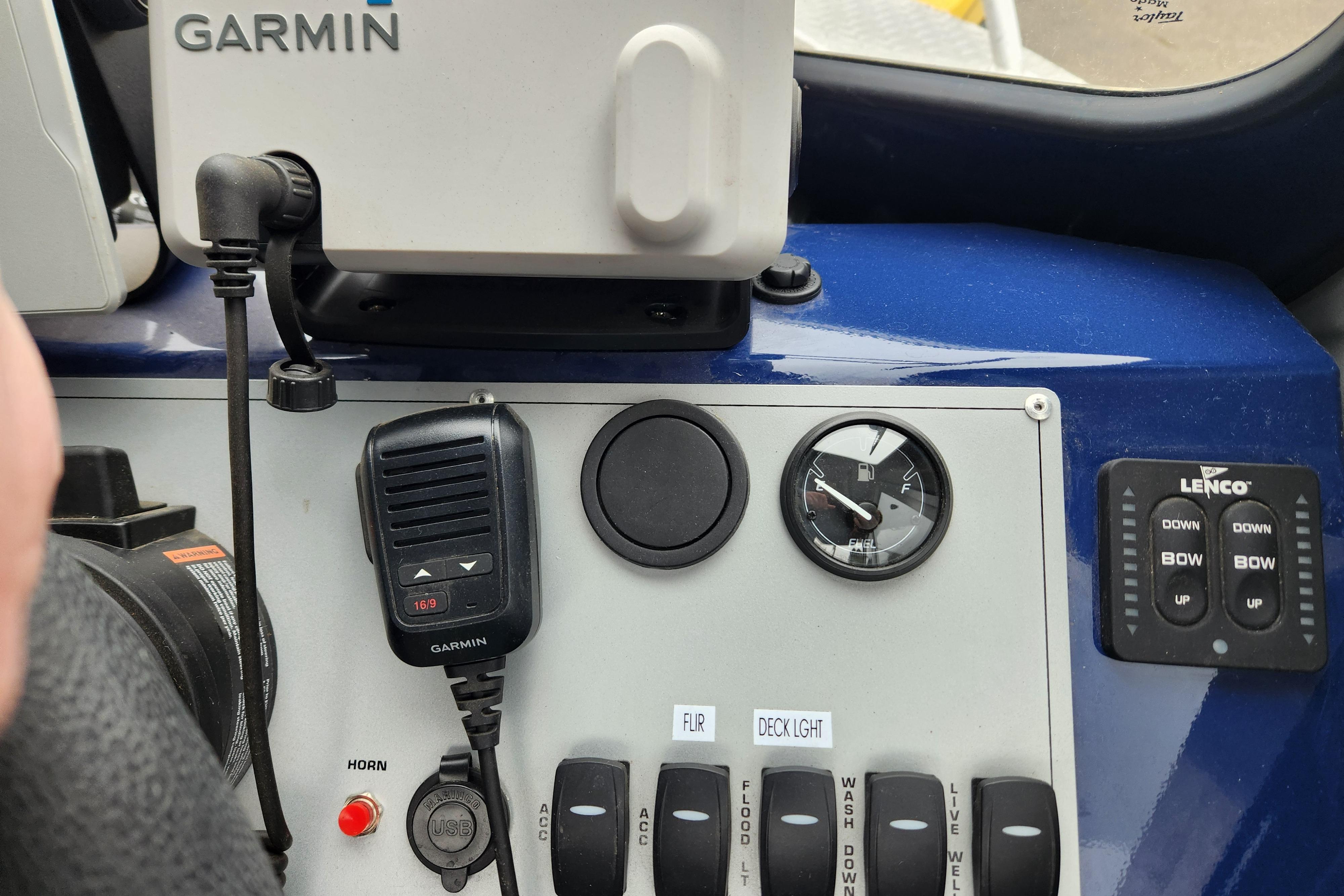 Control panel of 2025 Thunder Jet 21 Chinook OS with Garmin device and switches.